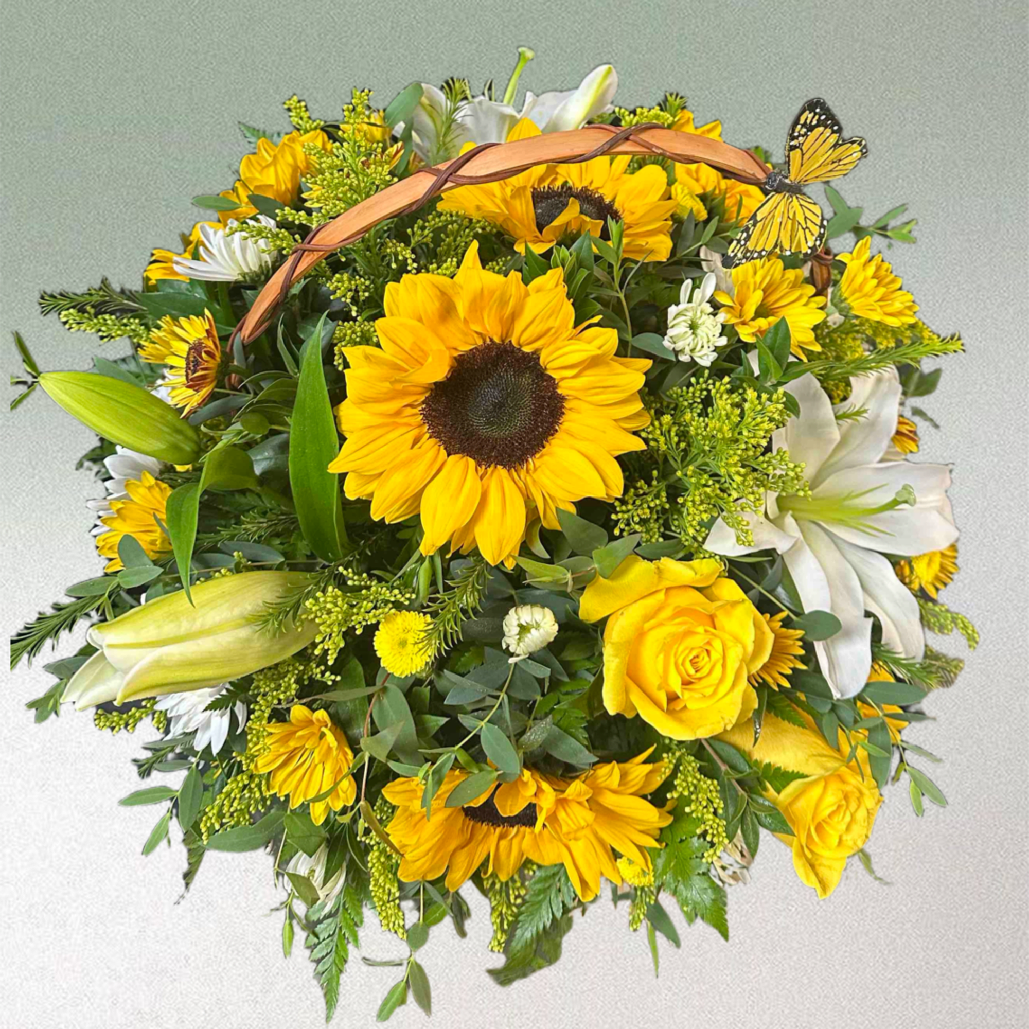 Basket with yellow roses, sunflowers, and lilies