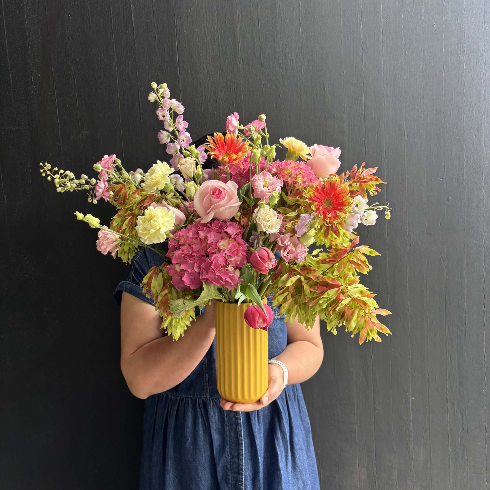 A Bright and refreshing design of garden hydrangeas, roses, and tulips. 

Our