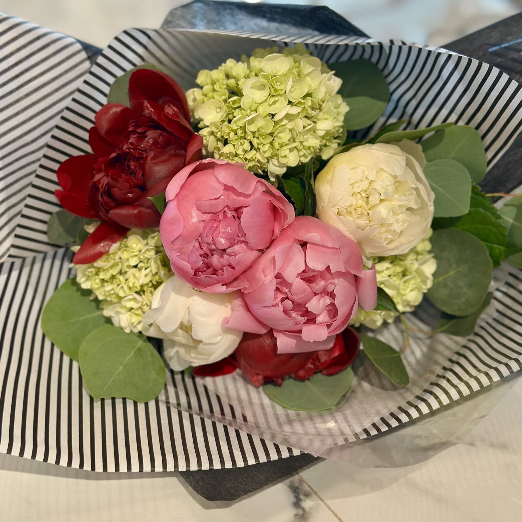 A beautiful hand-gathered bouquet of our prettiest Peonies &amp; Green Hydrangea, wrapped