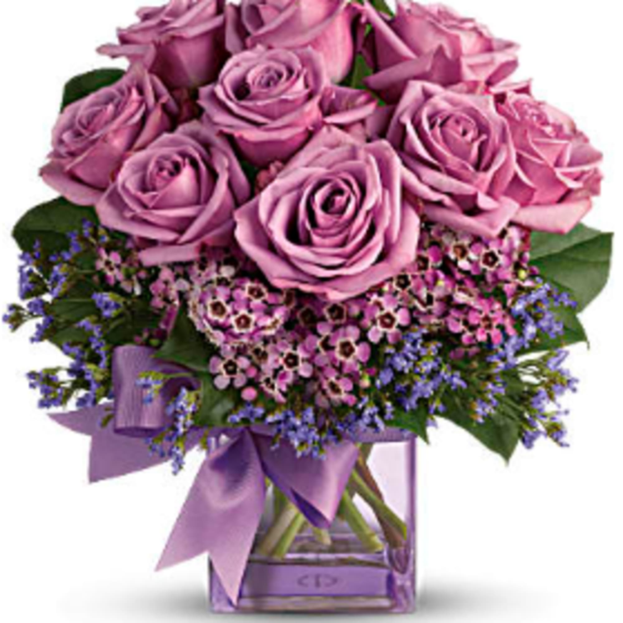 Lavender rose bouquet in a square glass vase with a purple ribbon