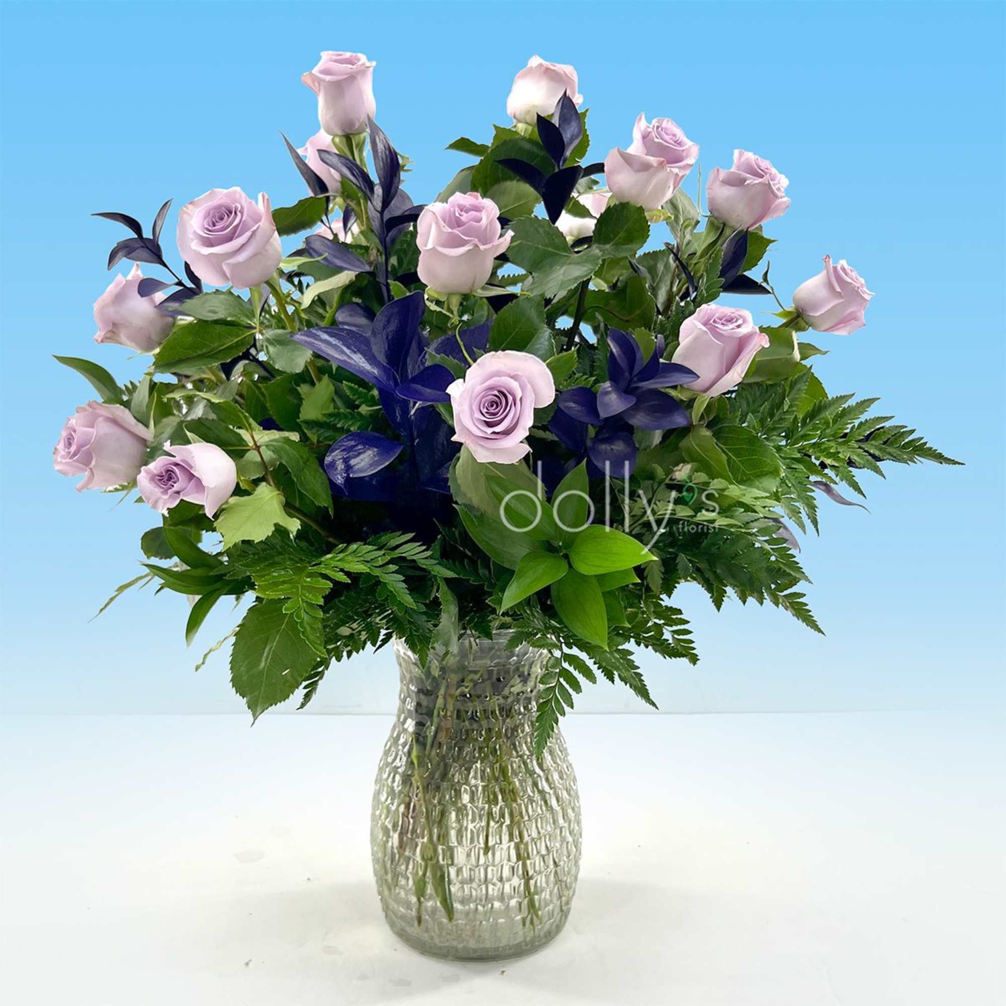 Lavender long-stem roses take center stage in this romantic bouquet, their soft