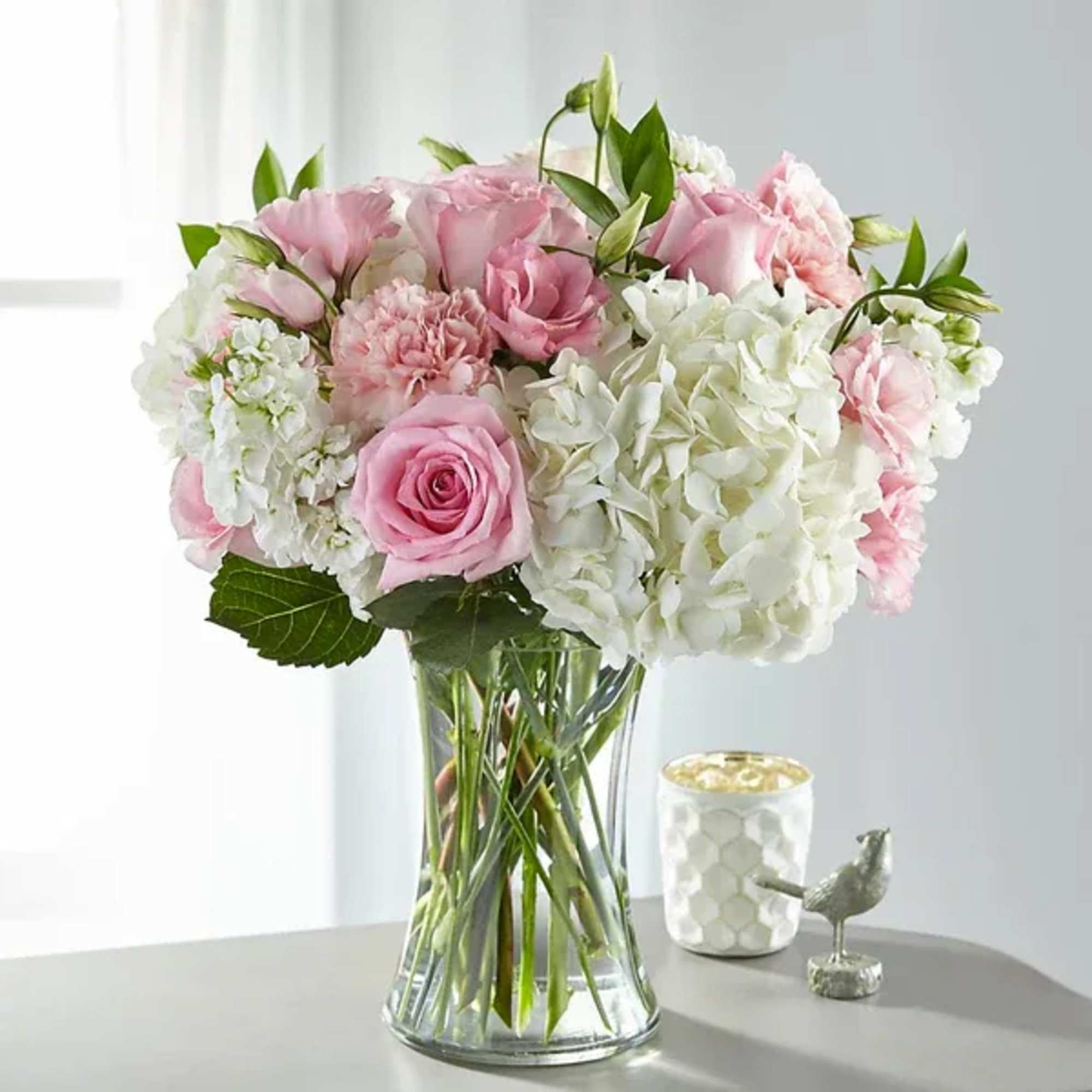 Pink and white flower bouquet in a clear glass vase