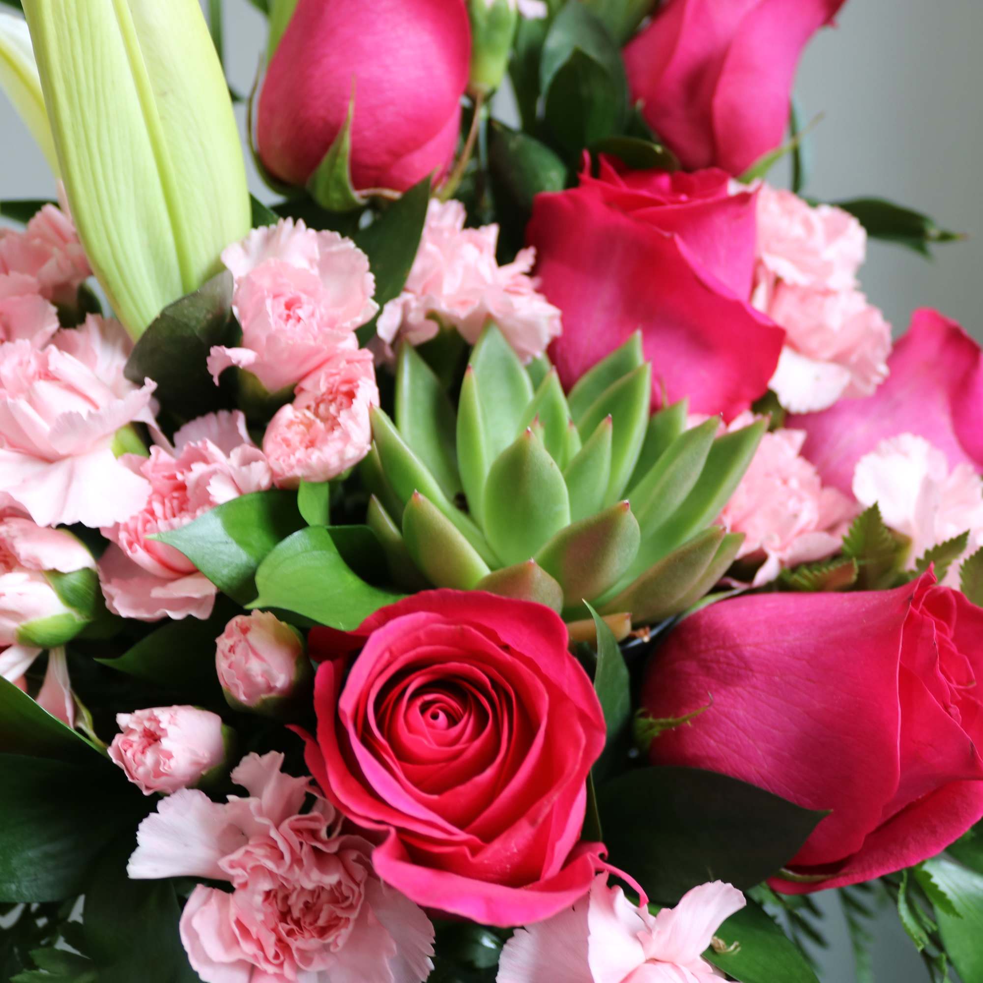 Bouquet of pink roses, carnations, and succulents