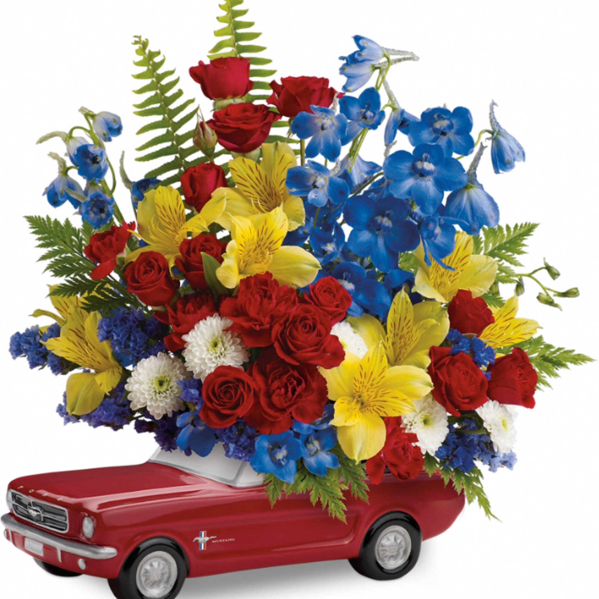 Red, yellow, and blue flower arrangement in a red toy car container