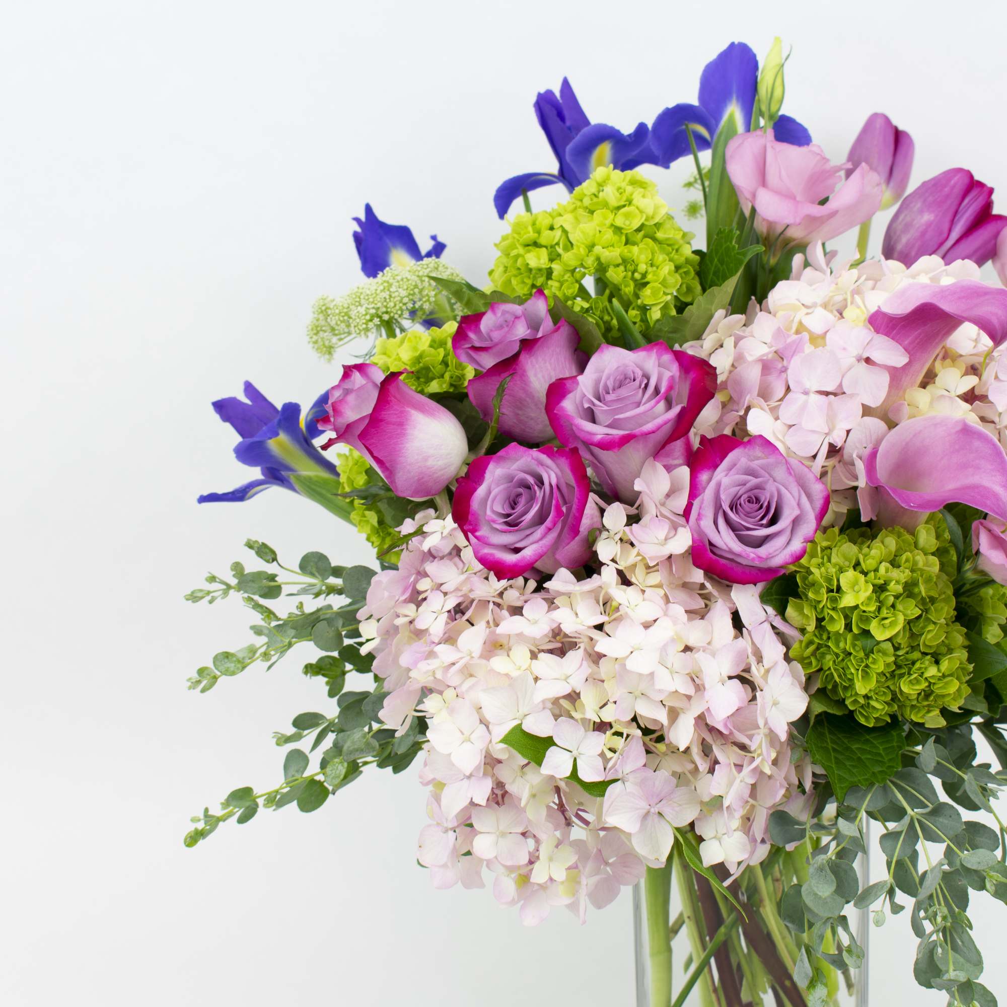 Bouquet of pink and purple flowers in a clear vase
