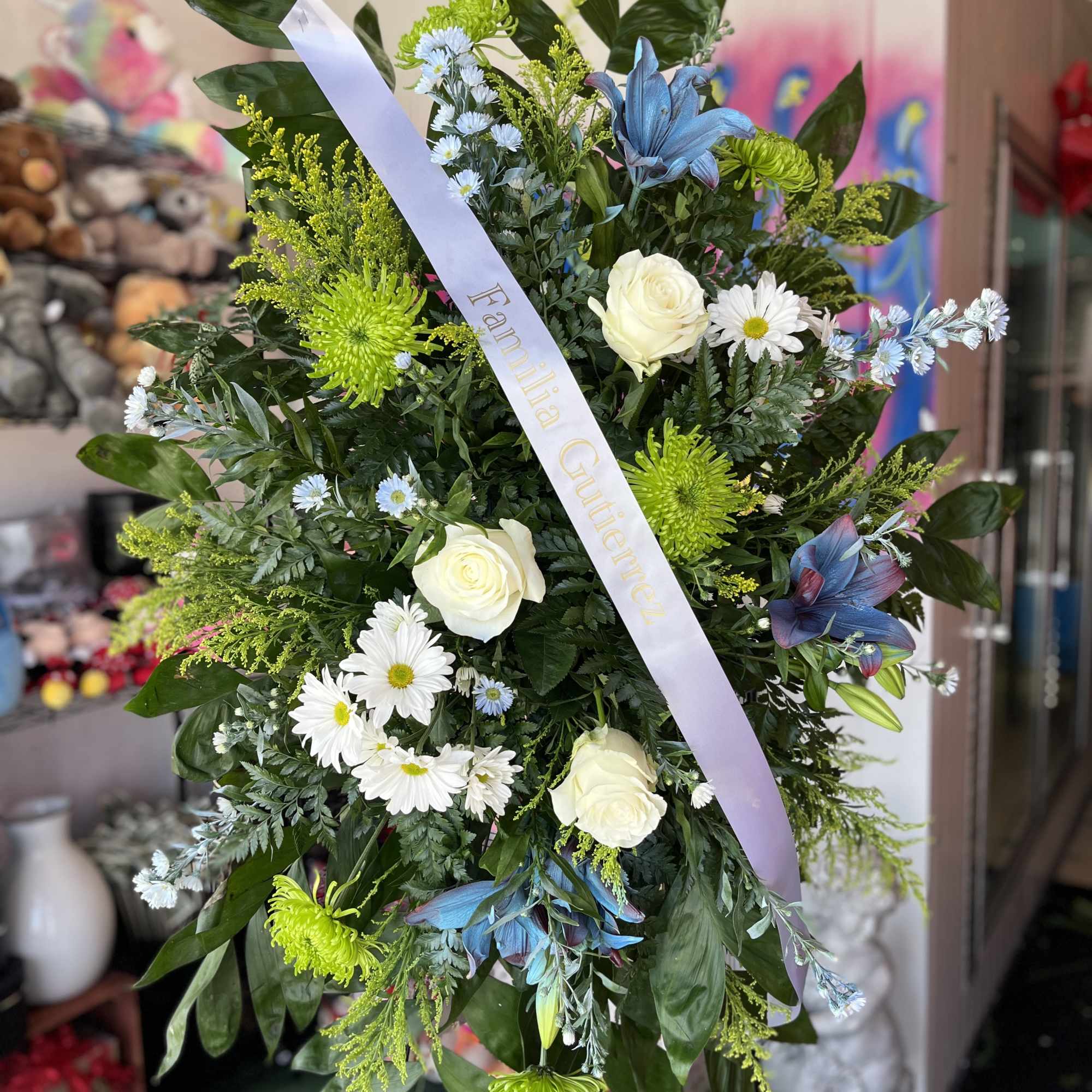 A tall, formal standing sympathy arrangement that reads as a respectful and