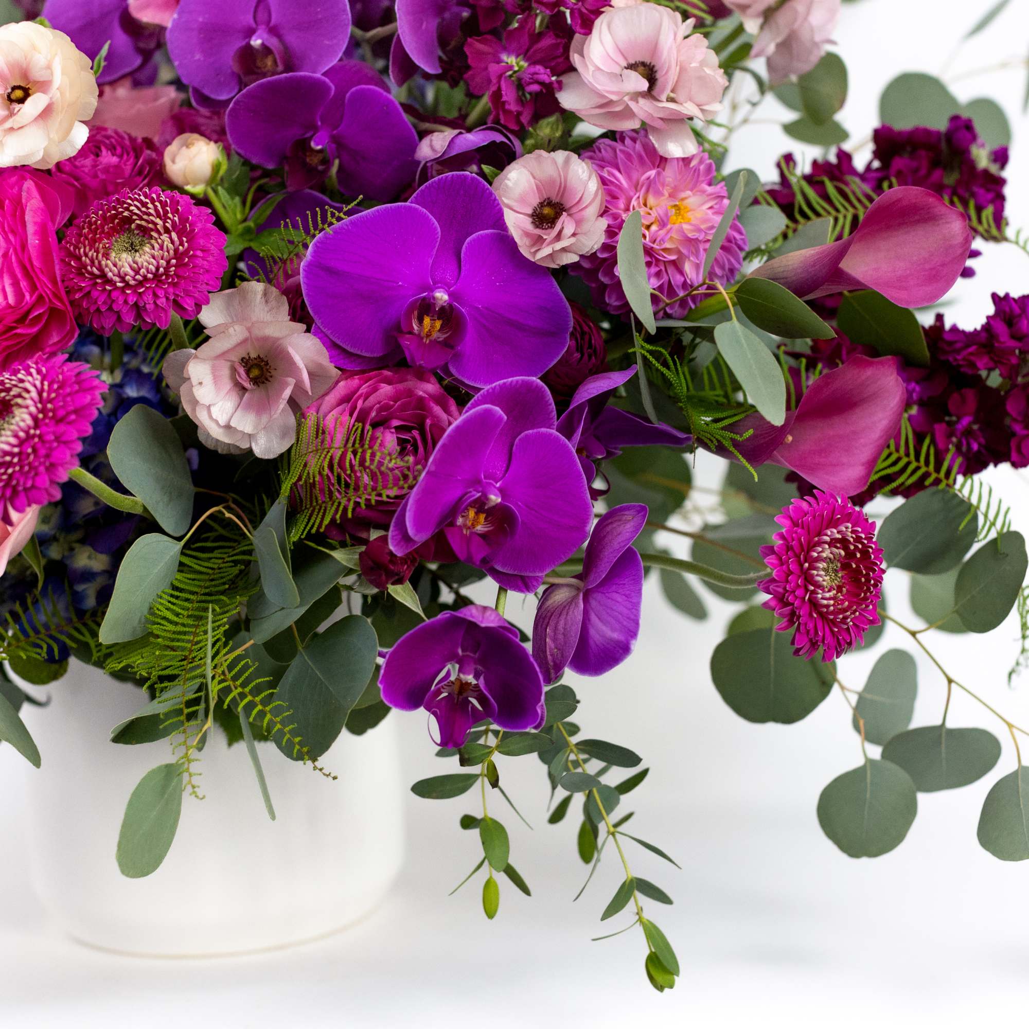 Pink and purple mixed bouquet in a white vase