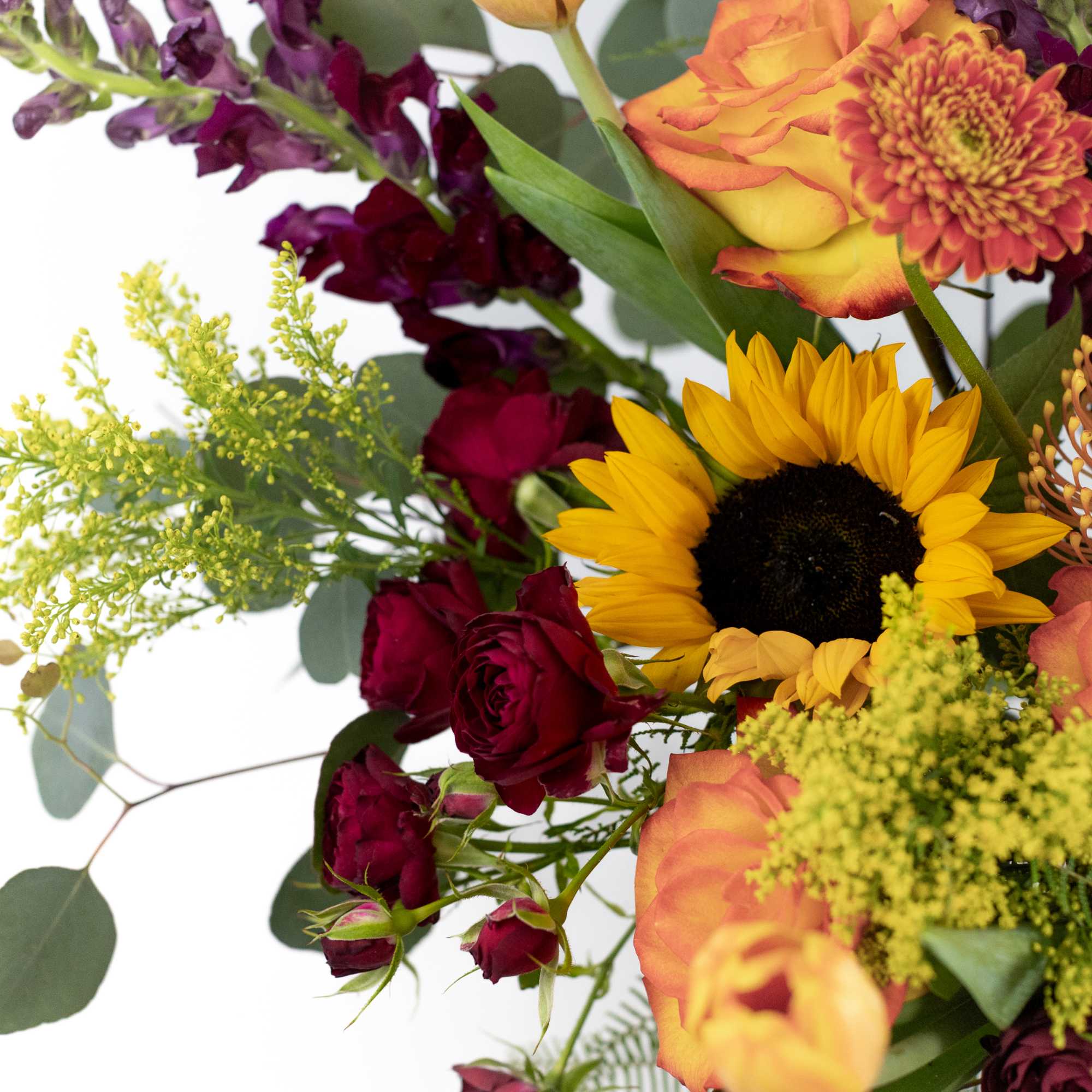 Mixed bouquet with sunflowers, roses, and orange blooms