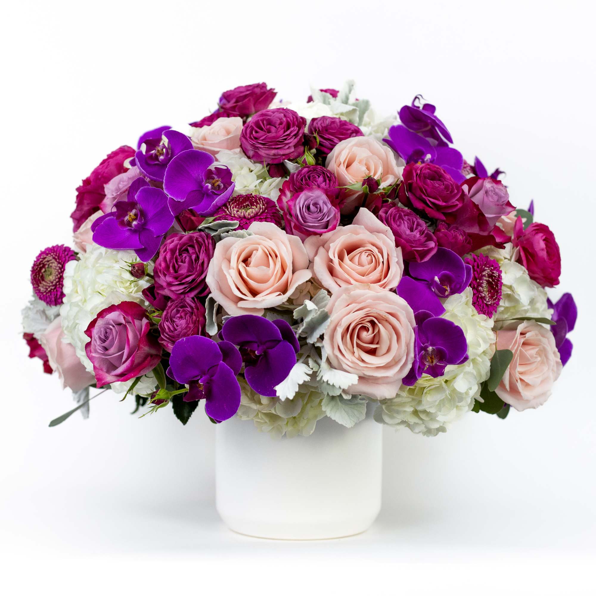 Bouquet of pink and purple flowers in a white vase