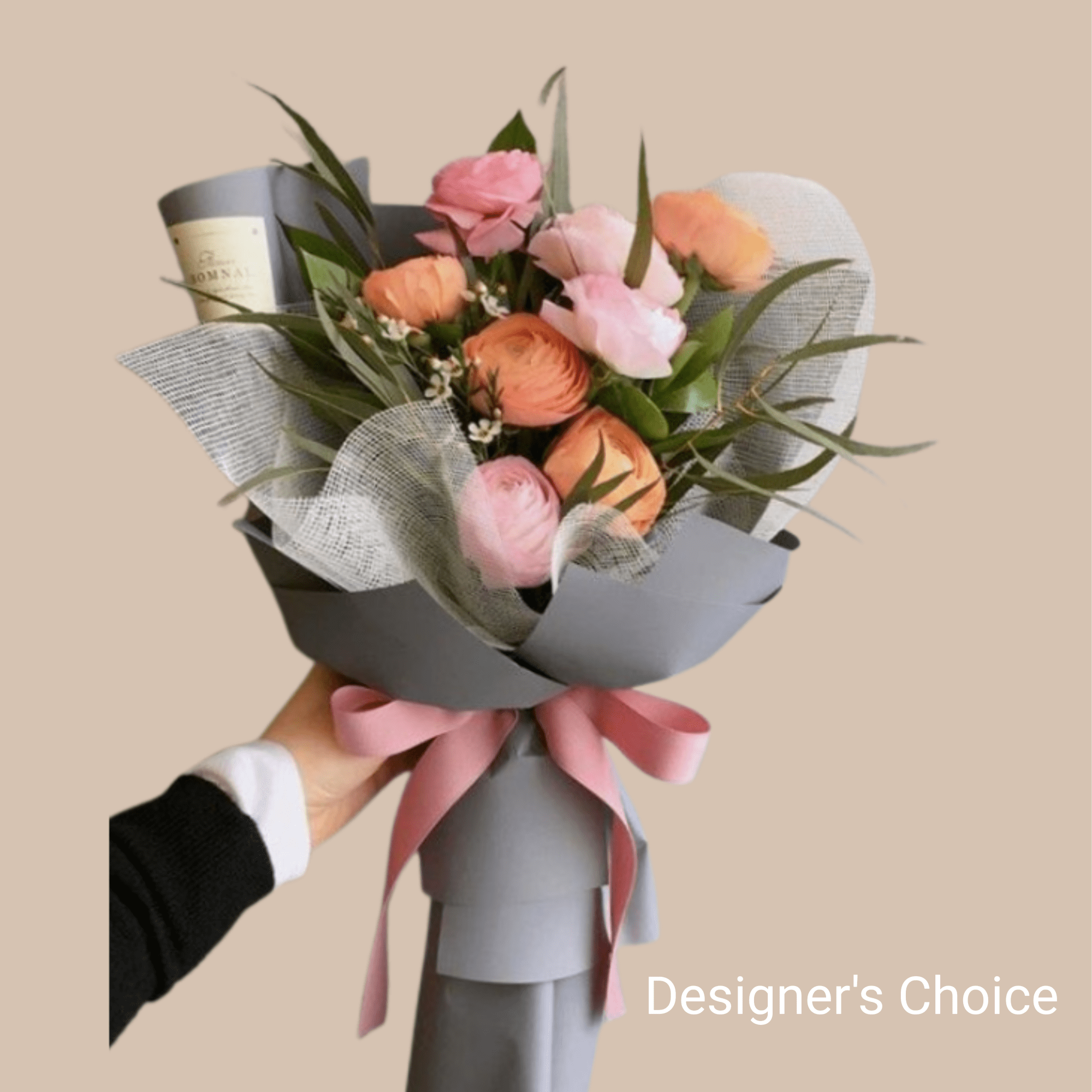 Mixed colored flowers mingle with airy white filler and long, slender greenery