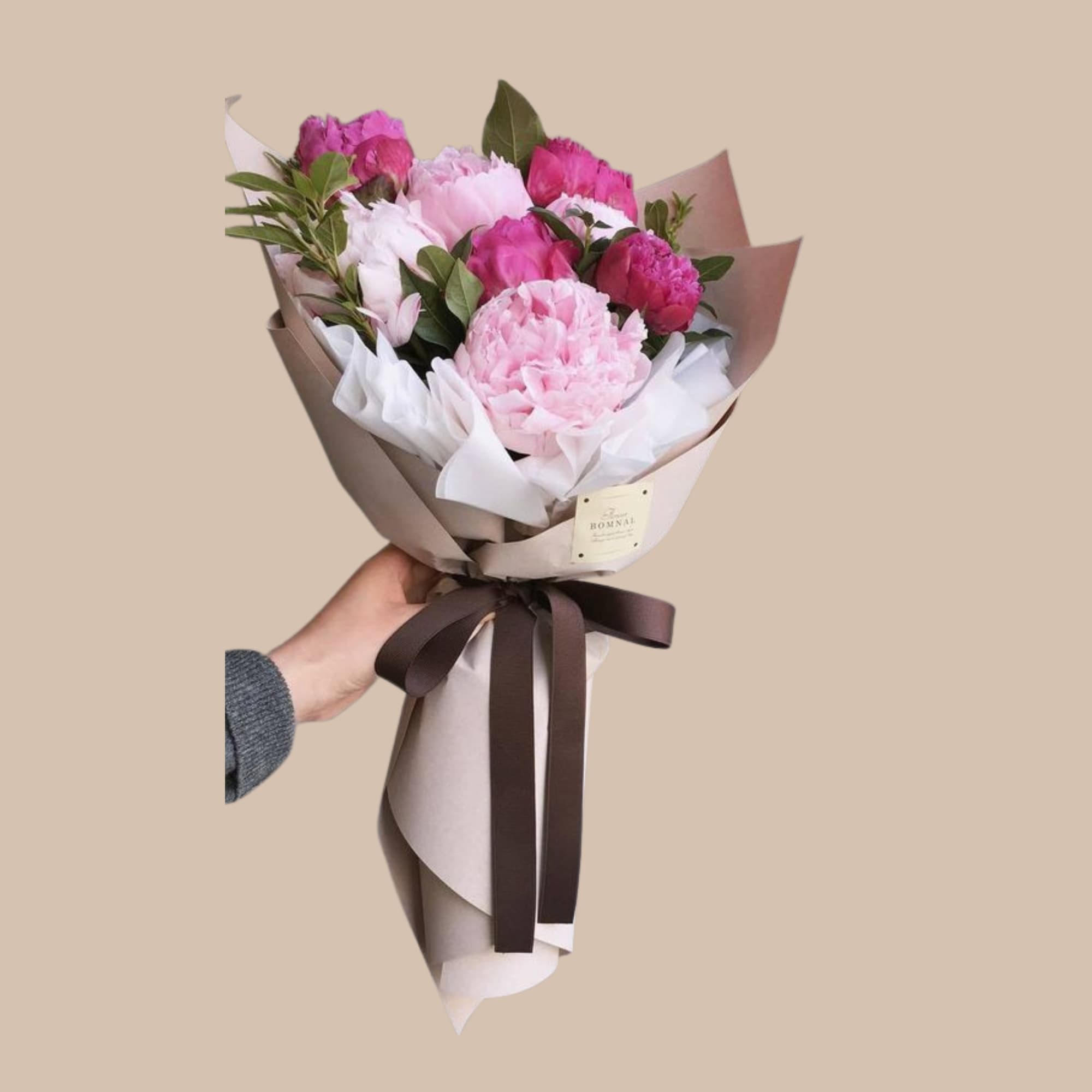 Lush, layered peony blooms in soft pink, creamy white, and deeper magenta