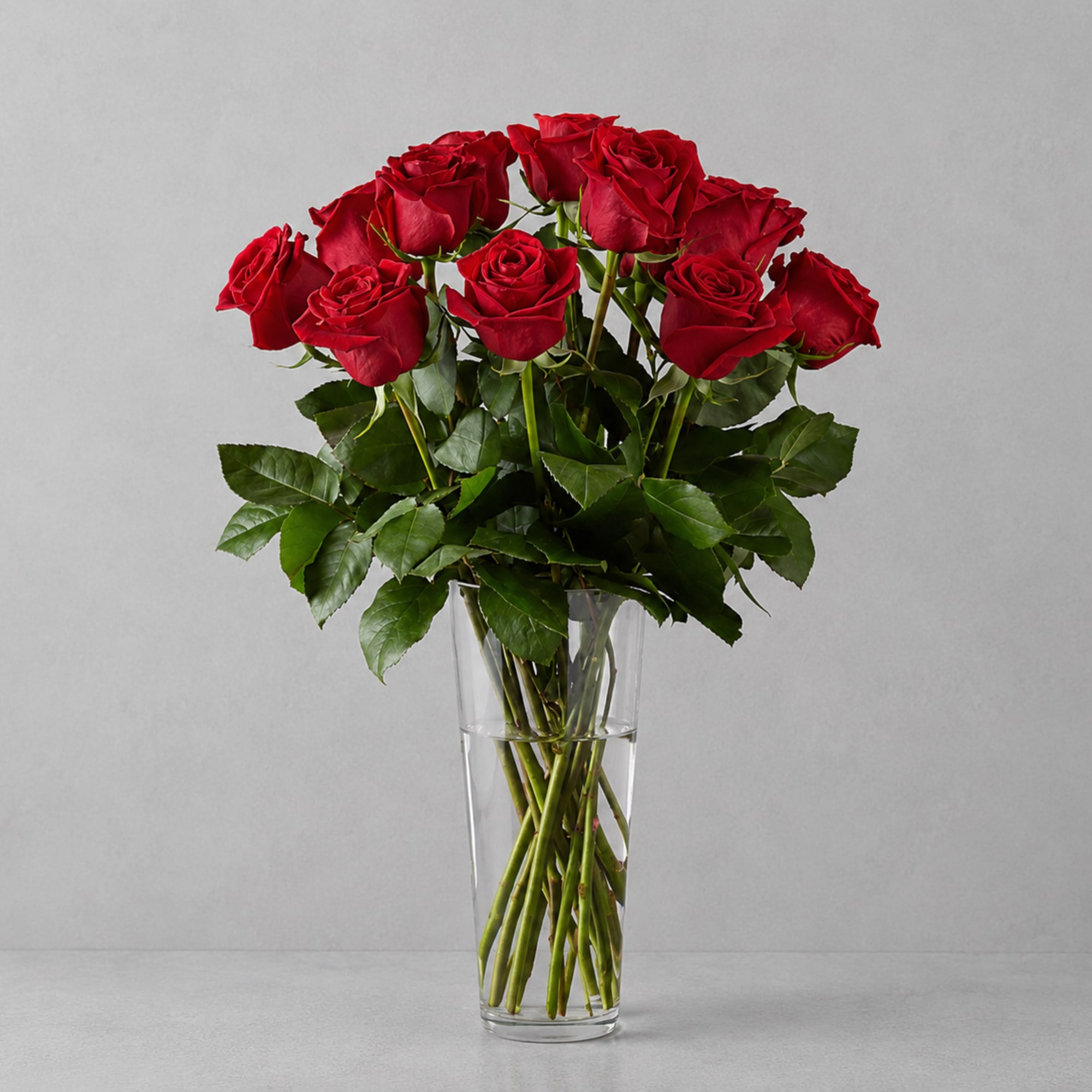 A stunning bouquet of half dozen vibrant red roses, elegantly arranged with
