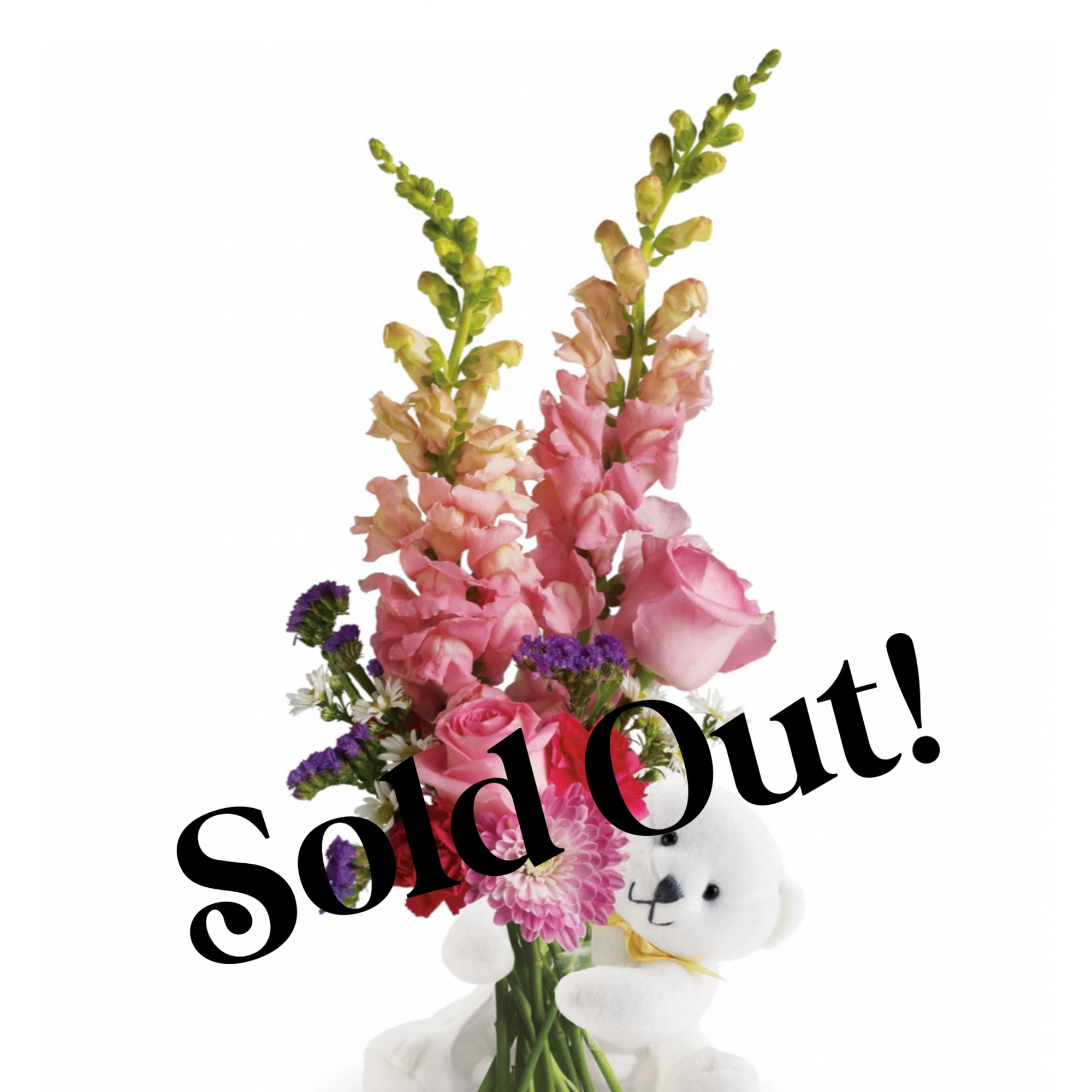 Pink flower arrangement with a white teddy bear in a vase