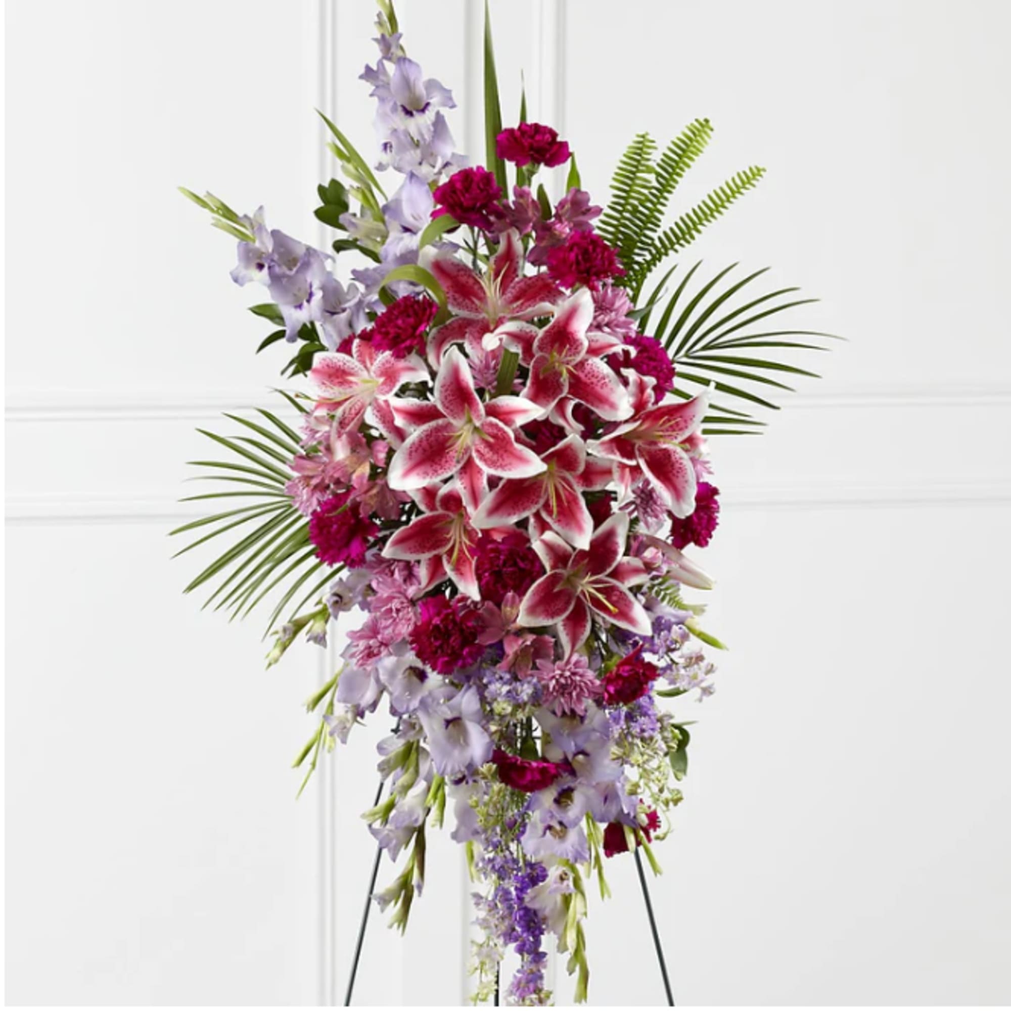 Tall standing spray of pink lilies and lavender flowers