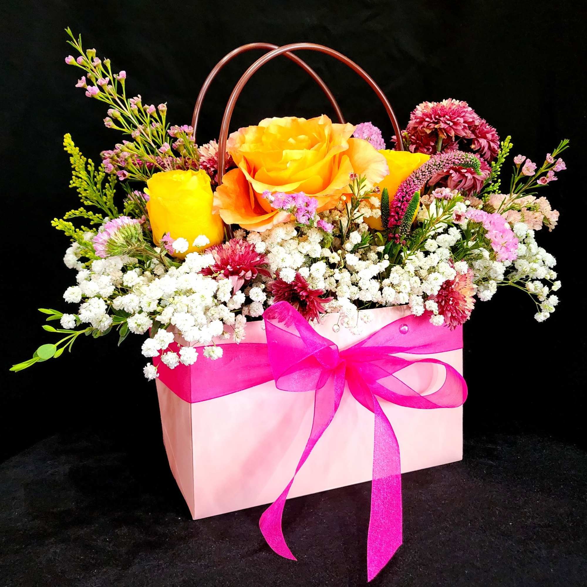 Surprise your loved one with this beautiful tote inspired arrangement with gorgeous