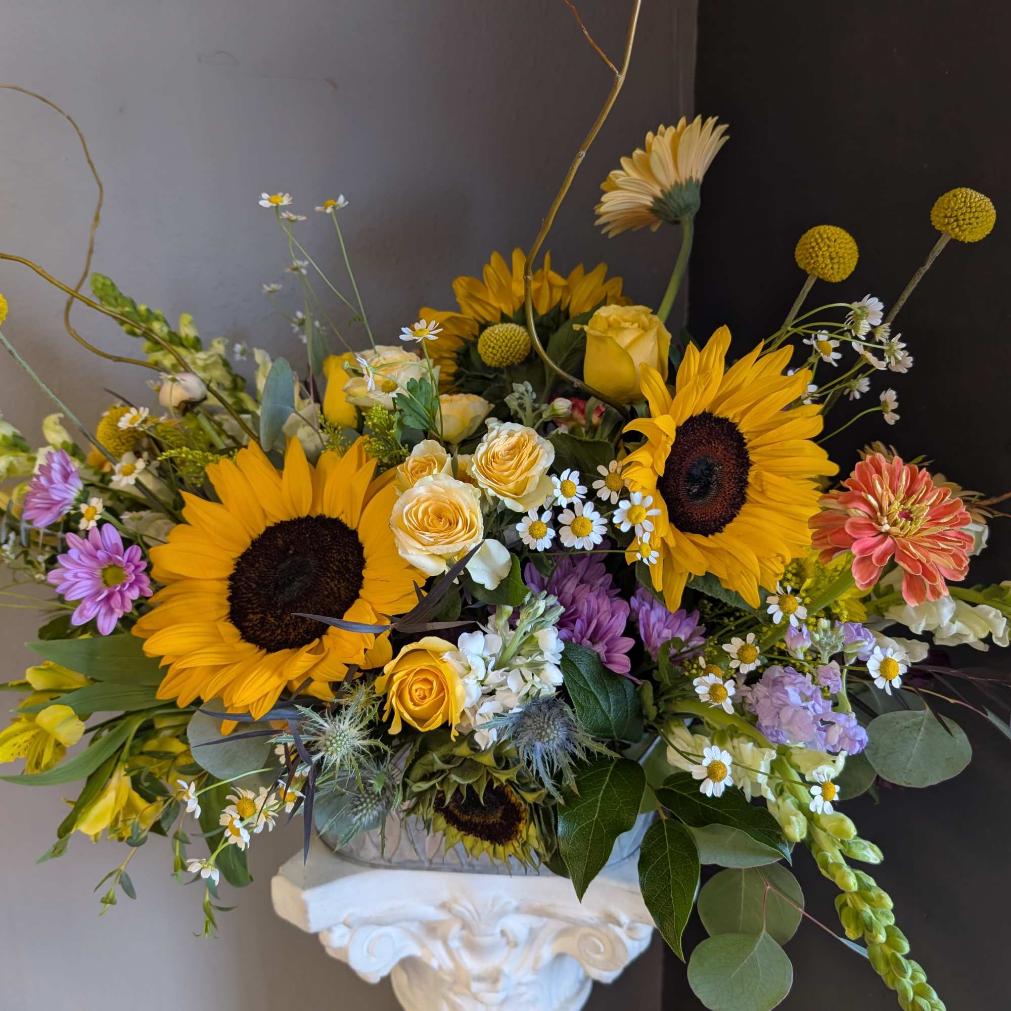 This beautiful flower arrangement of fresh mixed seasonal blooms is made by