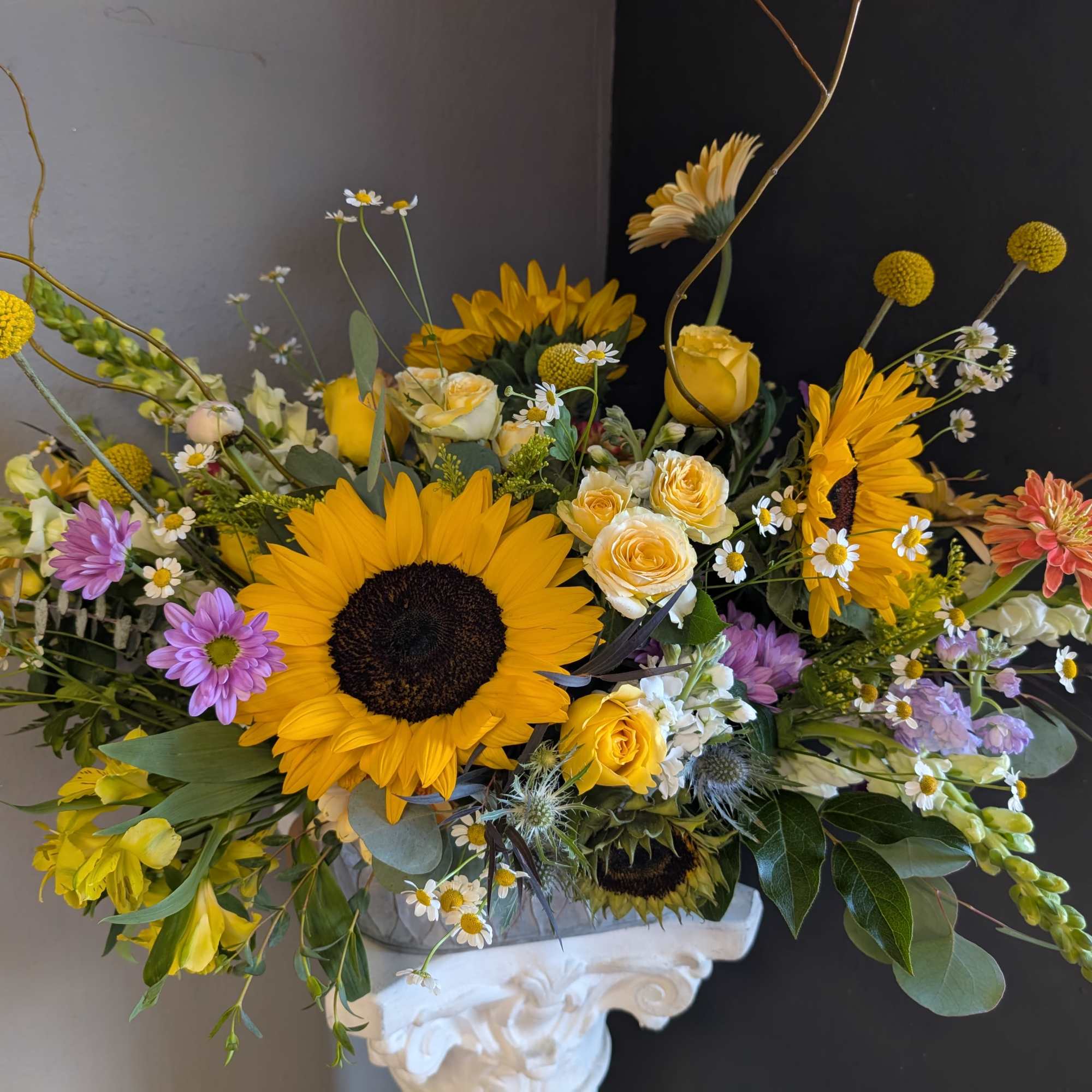 This beautiful flower arrangement of fresh mixed seasonal blooms is made by