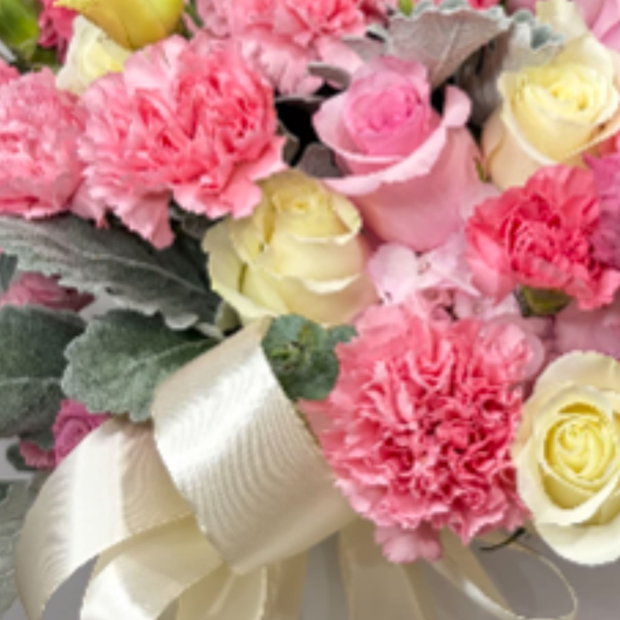 A luxurious floral arrangement designed in a modern white box, featuring a