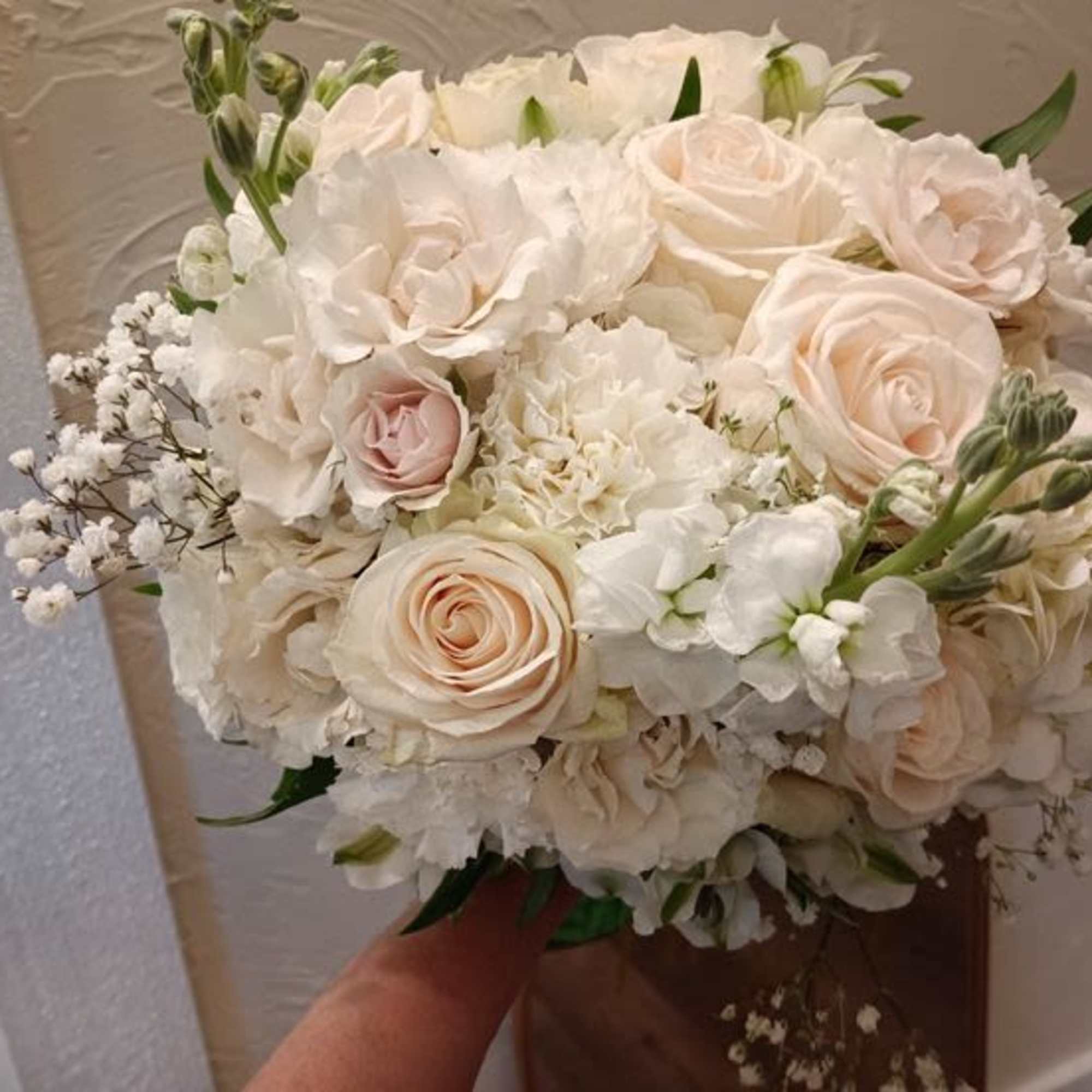 This bouquet is a graceful blend of soft neutrals and romantic textures