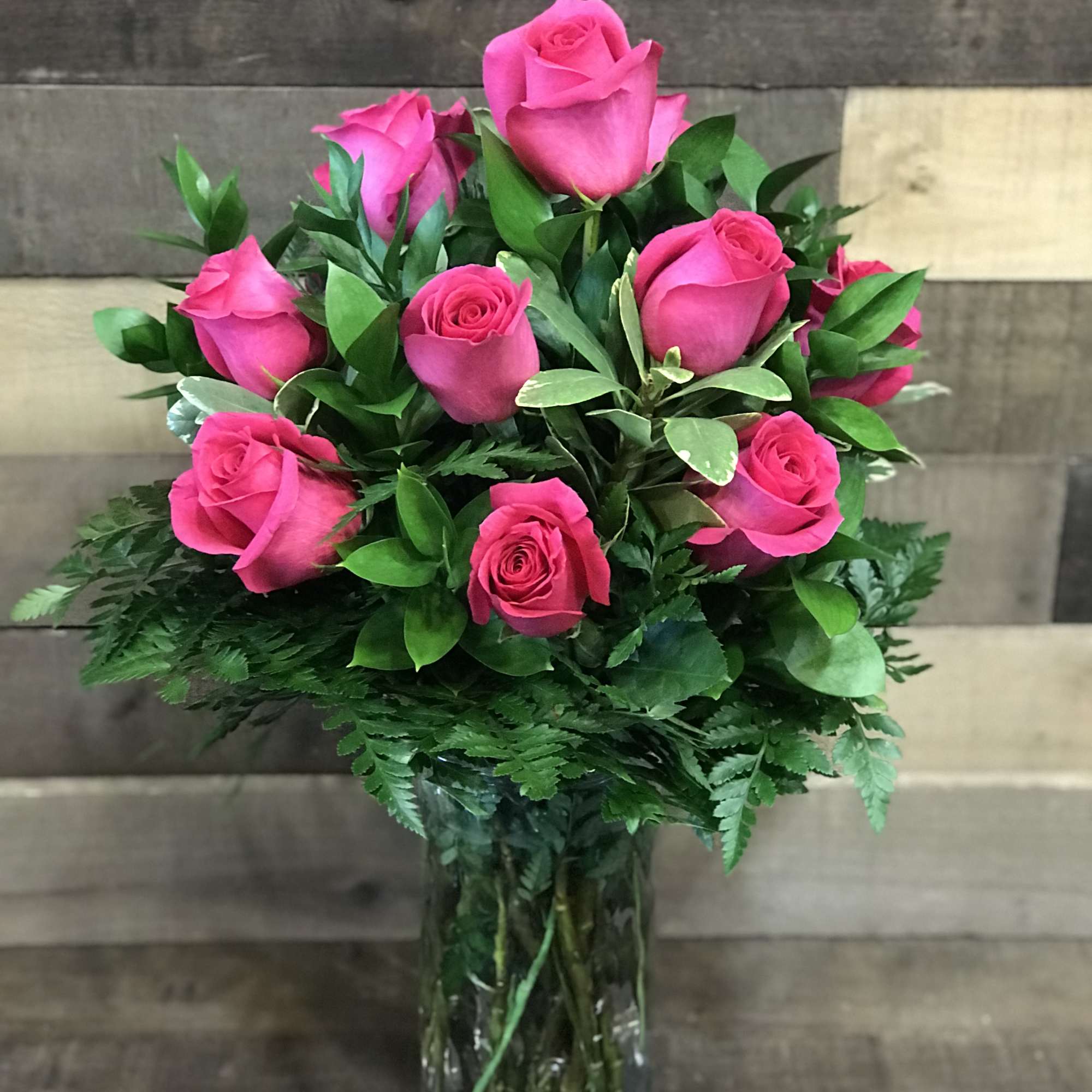 12 Hot Pink roses designed in a traditional style.
