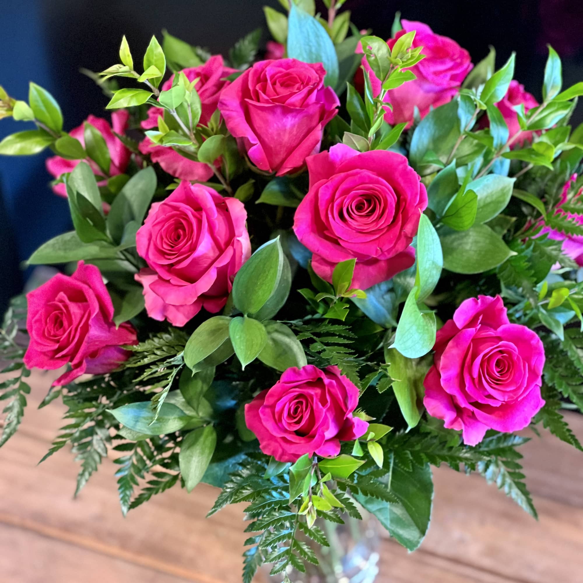 12 Hot Pink roses designed in a traditional style.
