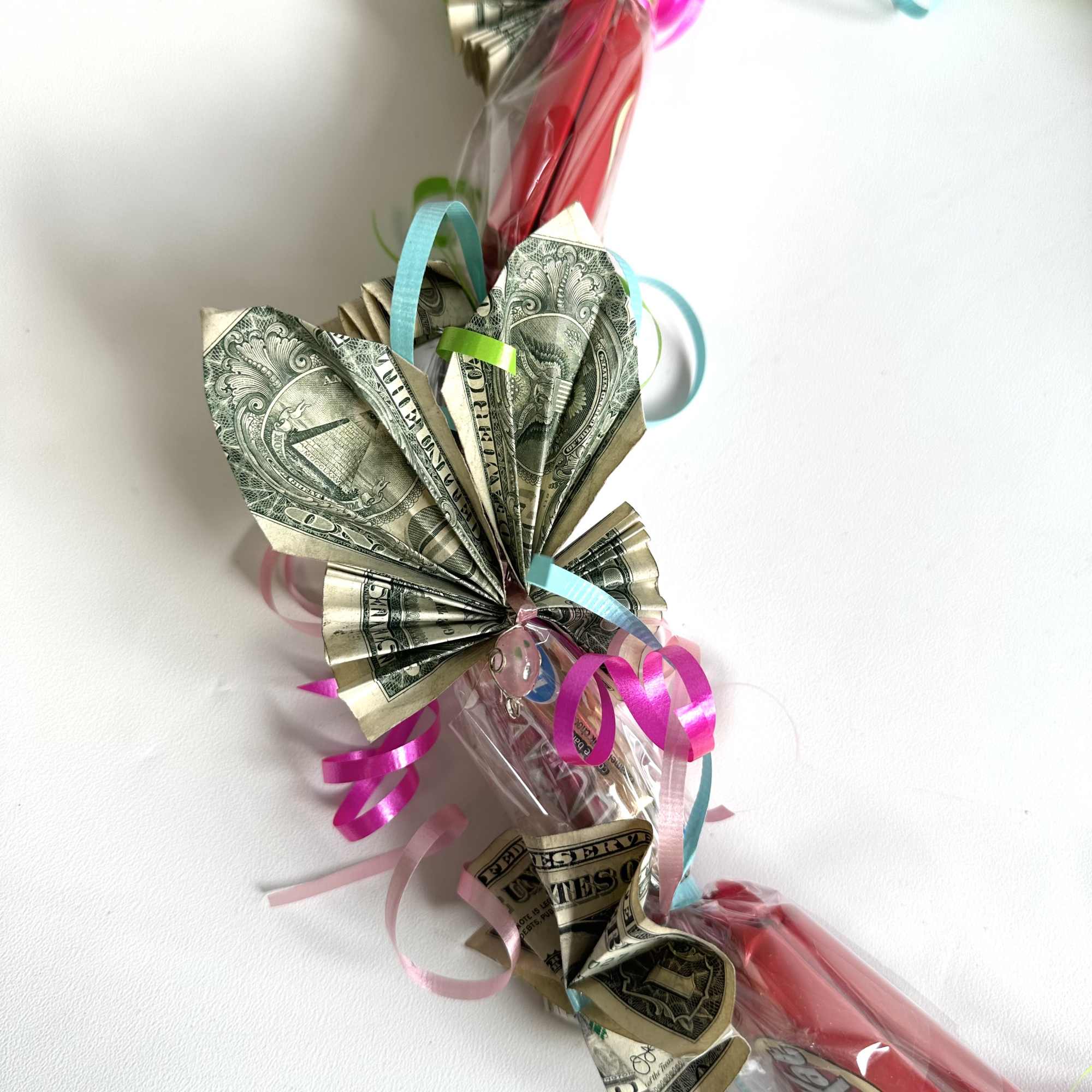 Money bouquet wrapped in clear plastic with colorful curling ribbons