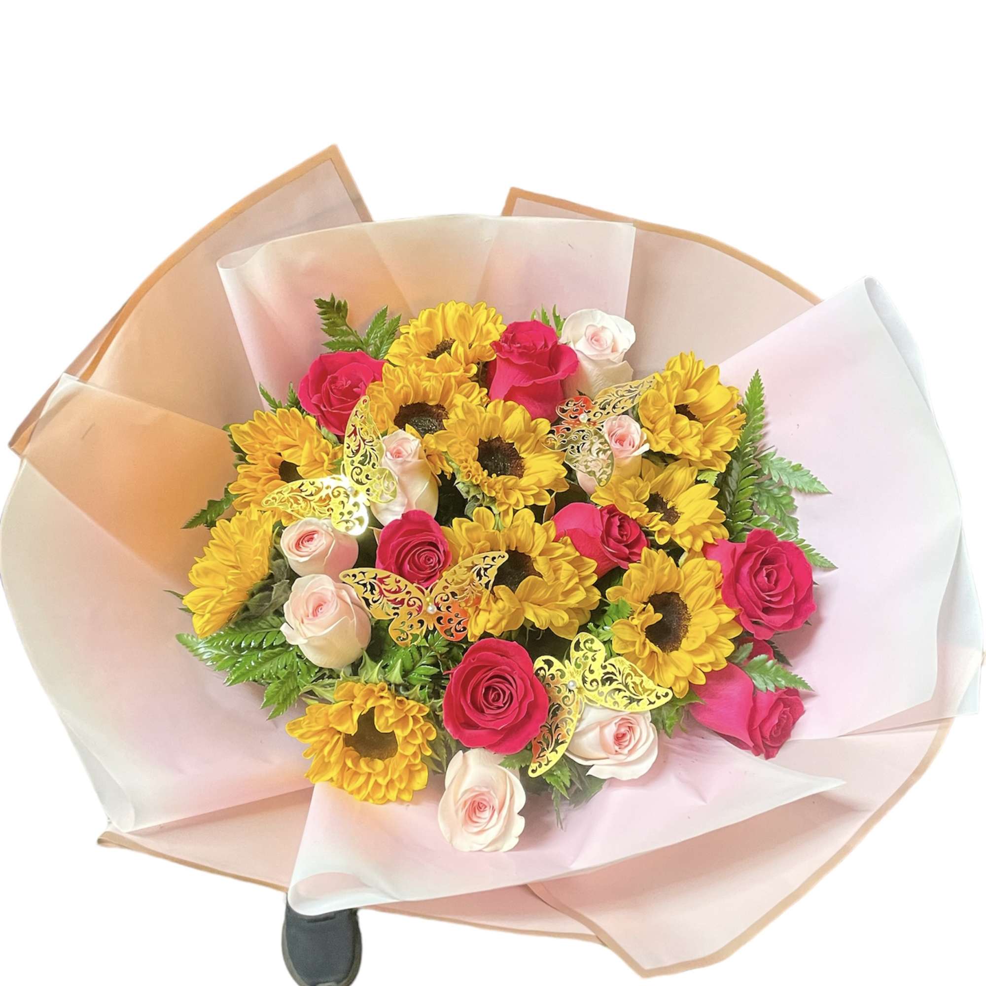 Bouquet of bright yellow sunflowers with hot pink and pale pink roses, wrapped in pink paper with gold butterfly accents