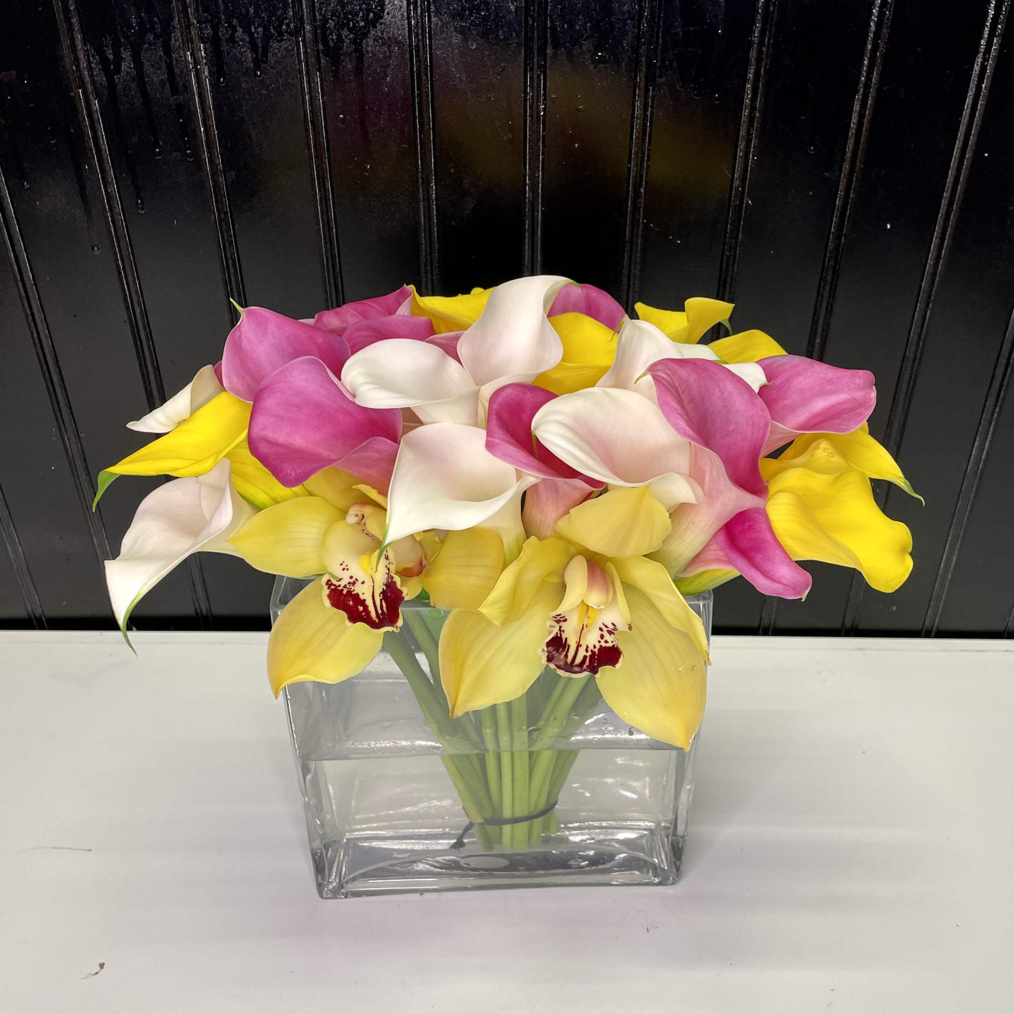 An special arrangement with beautiful calla lilies and cymbidium orchids