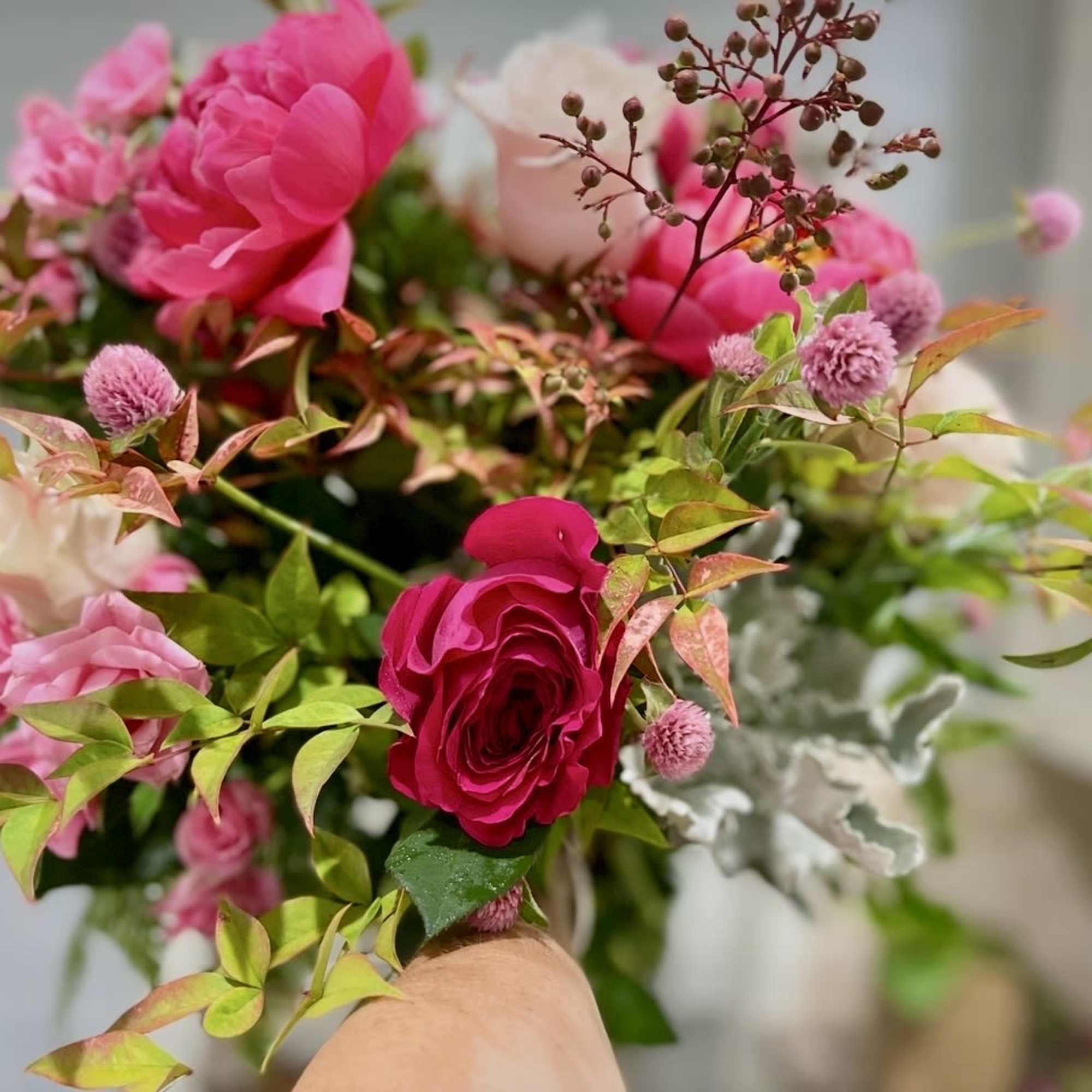 A gorgeous hand tie that is bright and beautiful with peonies and