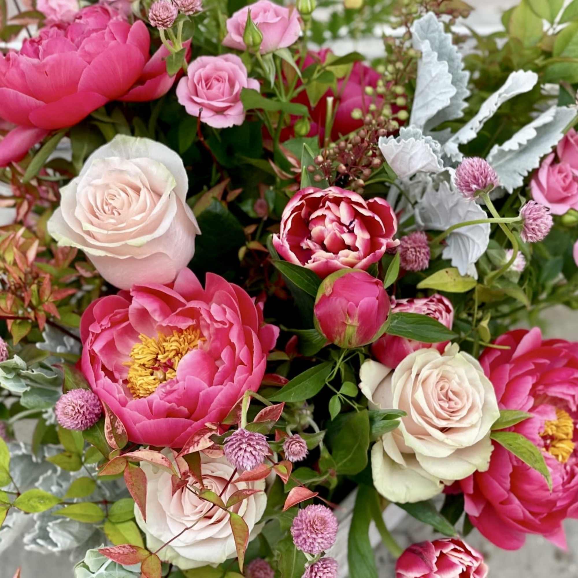 A gorgeous hand tie that is bright and beautiful with peonies and