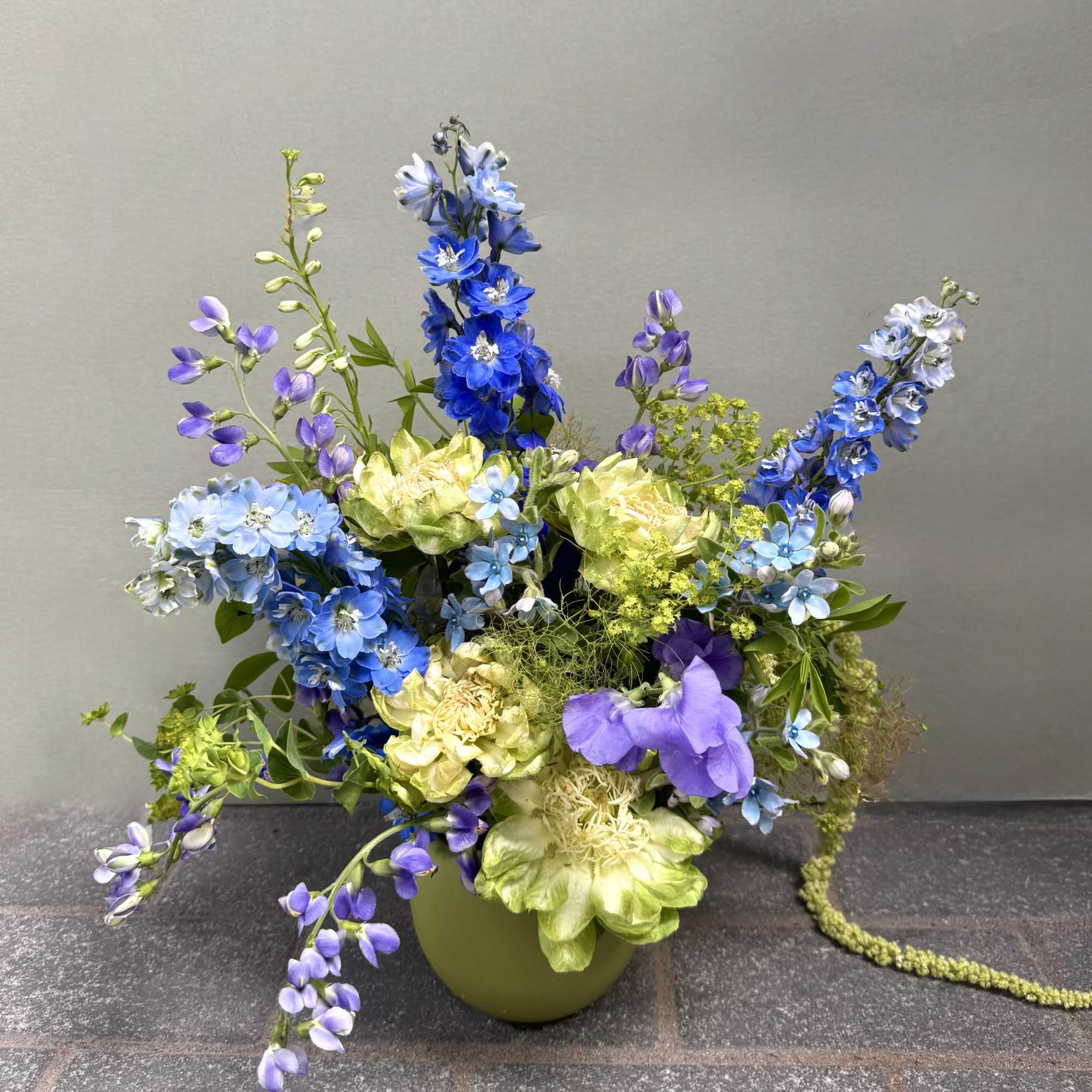 Tall spikes of blue and lavender delphinium set a dramatic, airy tone