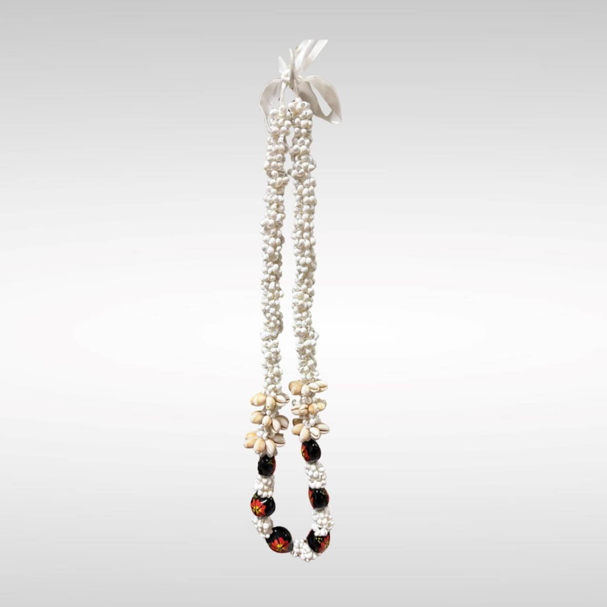 Kukui Lei Red and Black Flower with Small Seashells.
Made in the Phillipines.