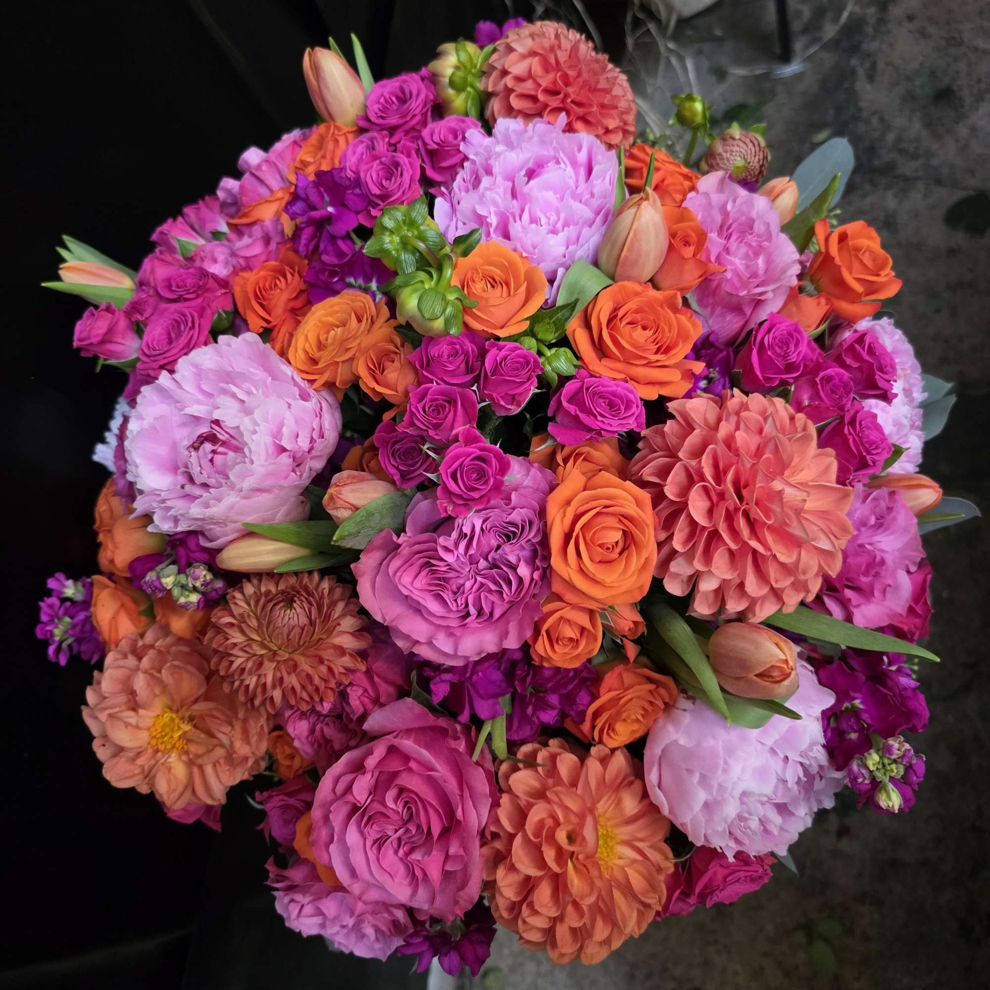 A lush, rounded celebration of color, this flower arrangement is a joyful