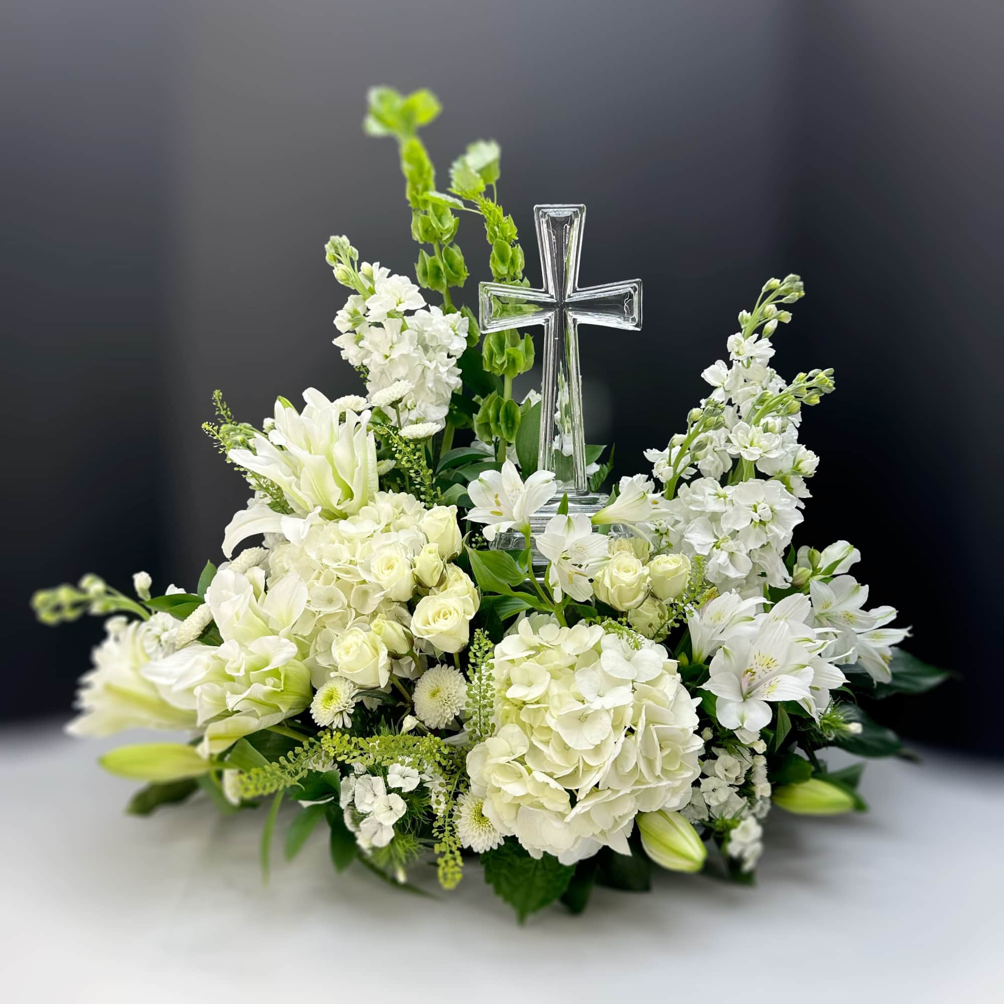 A luminous arrangement built around pure white lilies and airy hydrangeas creates