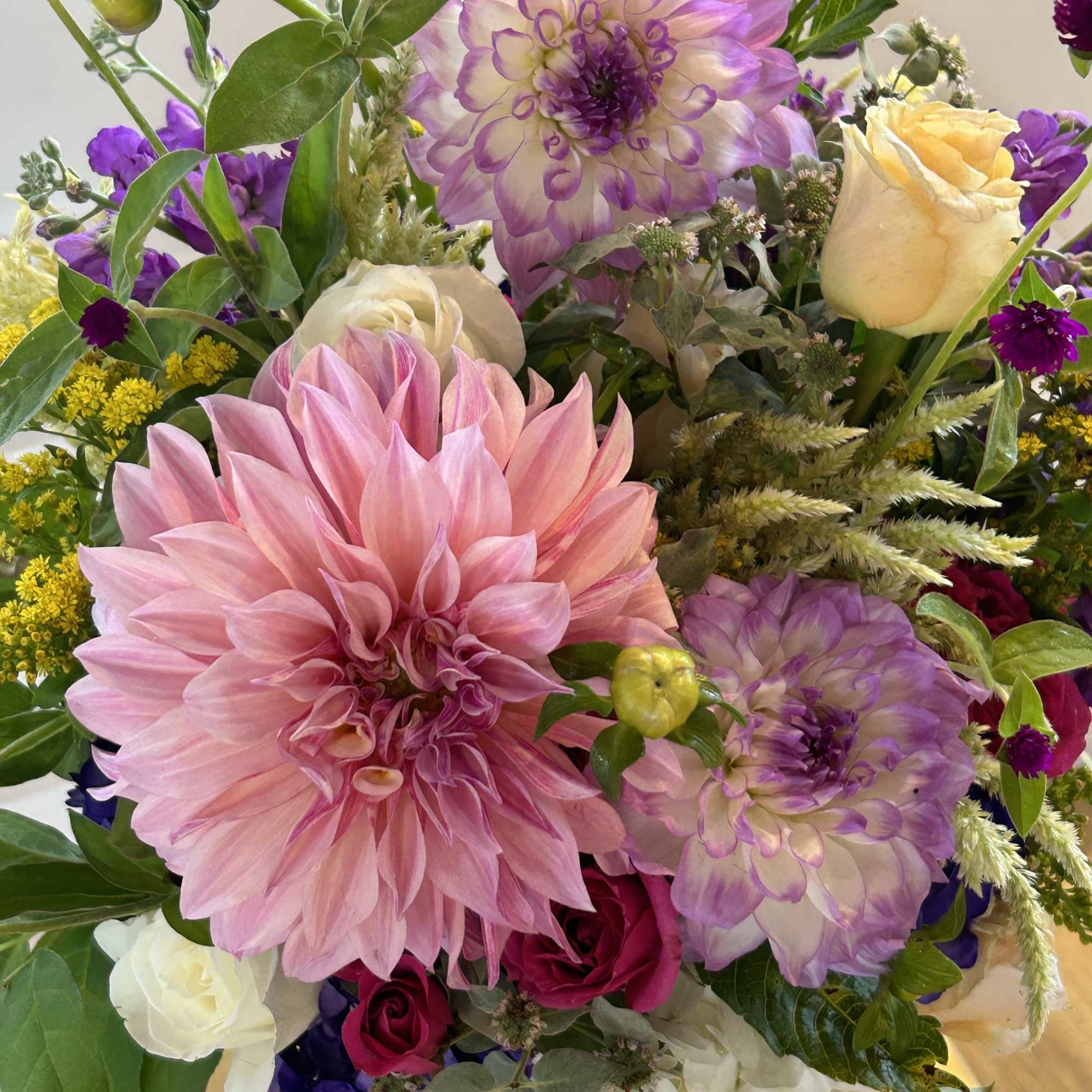 Pink and lavender mixed bouquet with roses in a vase