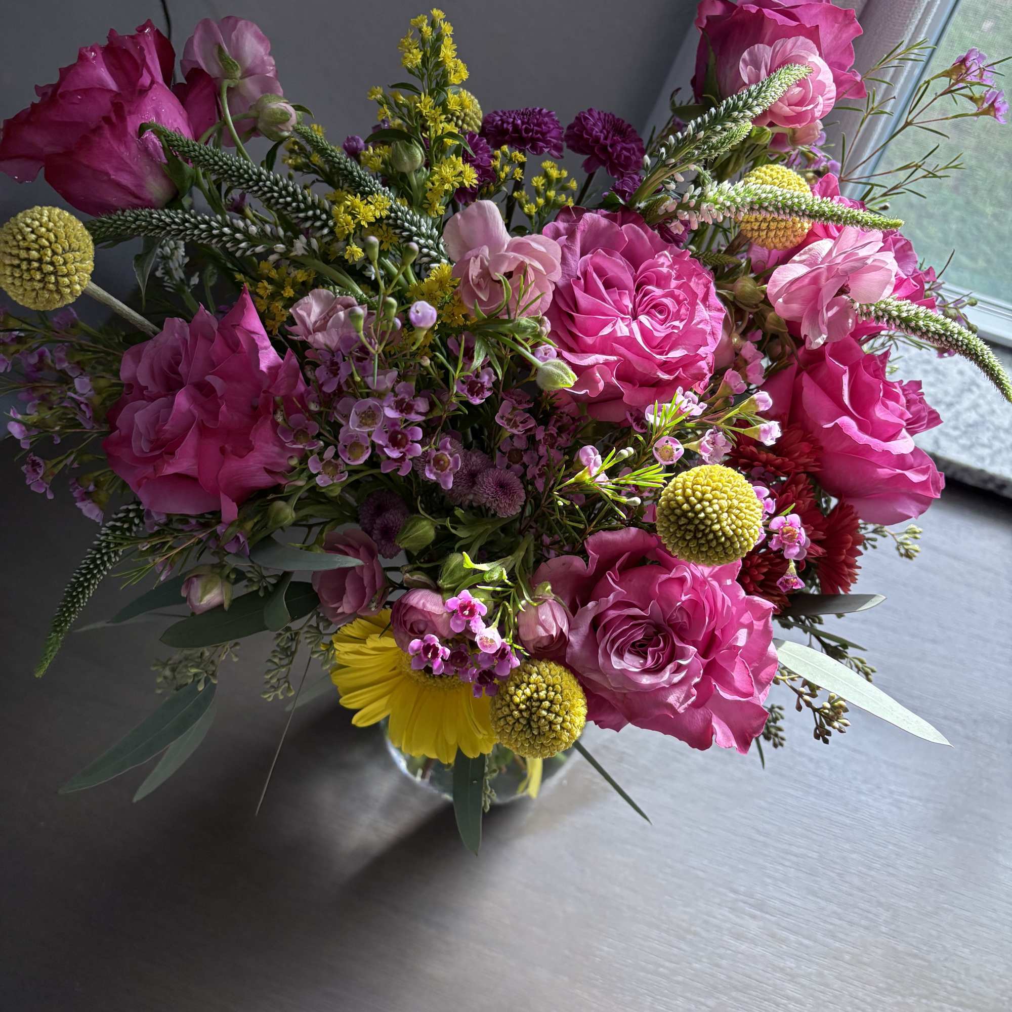 Pink and yellow mixed bouquet in a clear glass vase