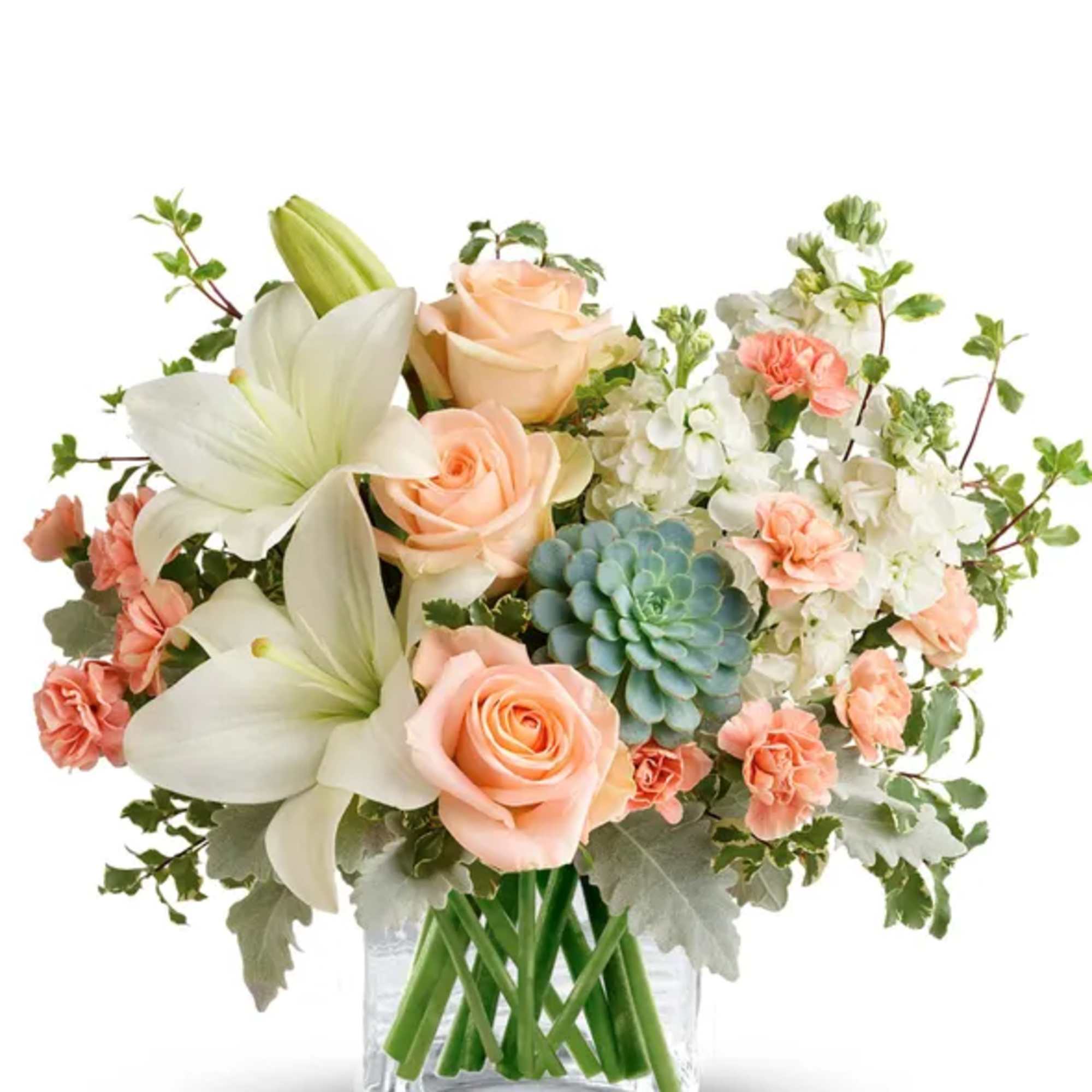 Peach roses and white lilies in a clear glass vase with a succulent accent