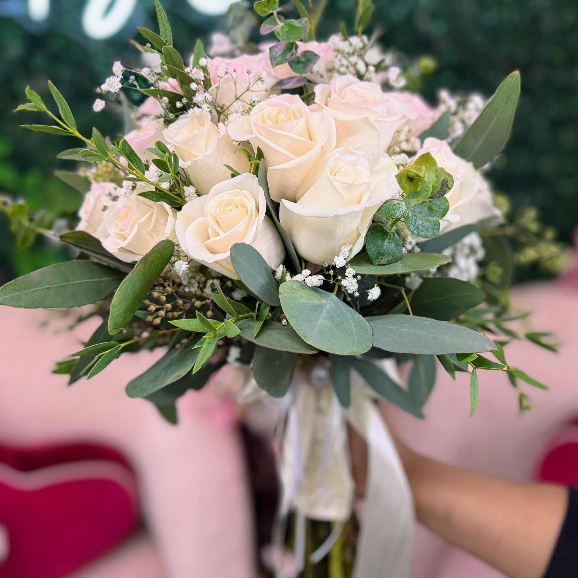 Bouquet of cream roses with greenery and baby's breath