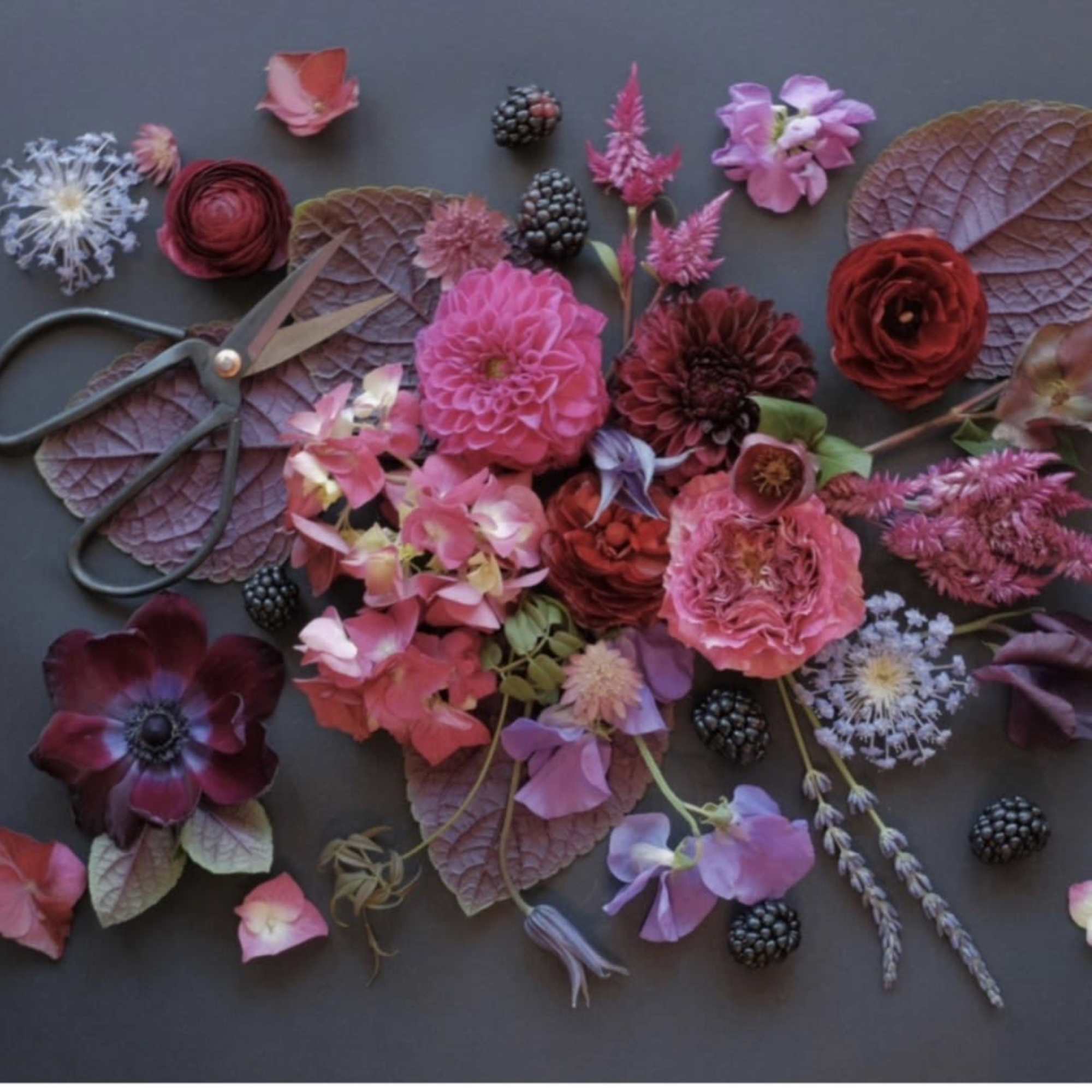 Bold, moody blooms in a romantic palette-this designer's choice floral arrangement brings