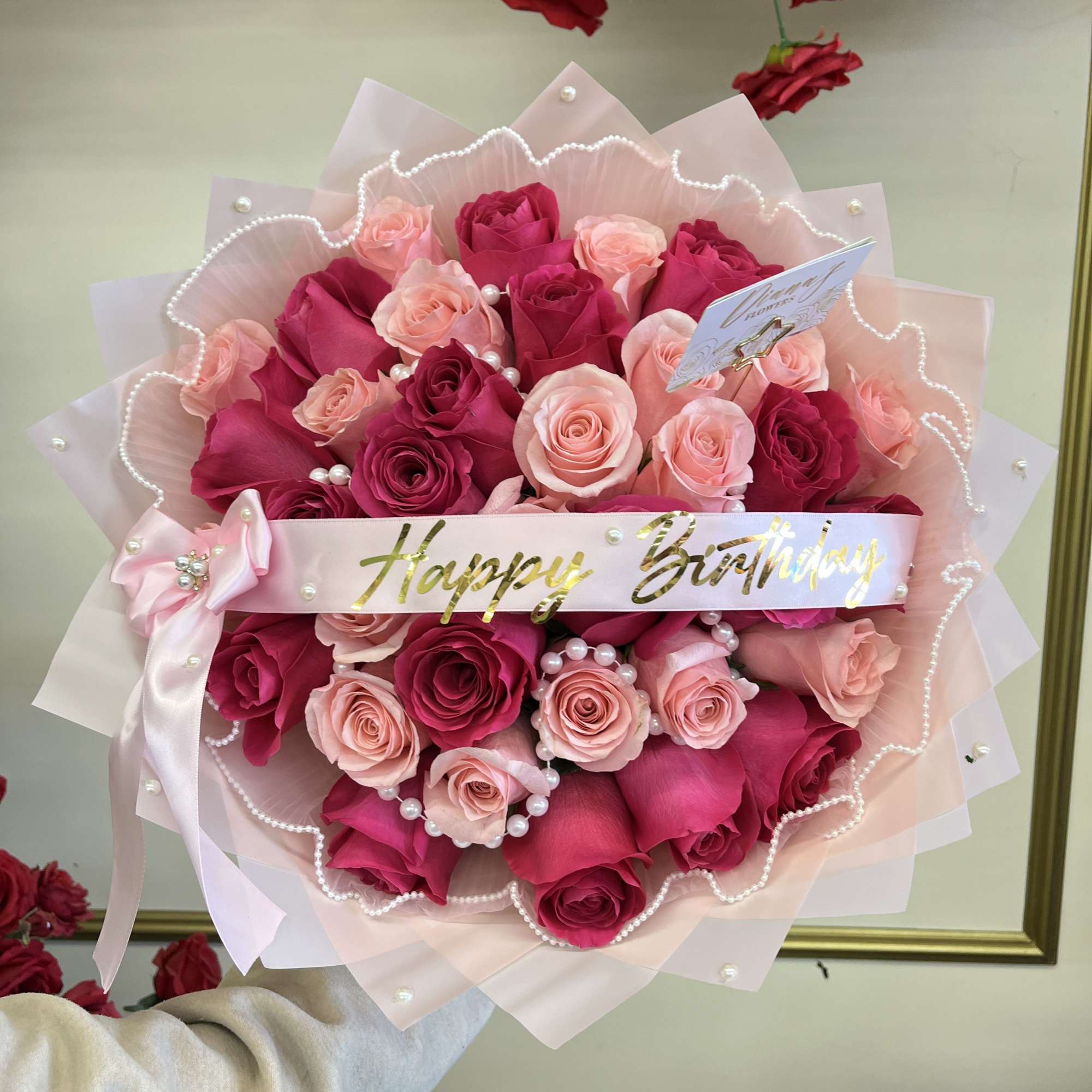 A stunning combination of hot pink and light pink roses, beautifully arranged