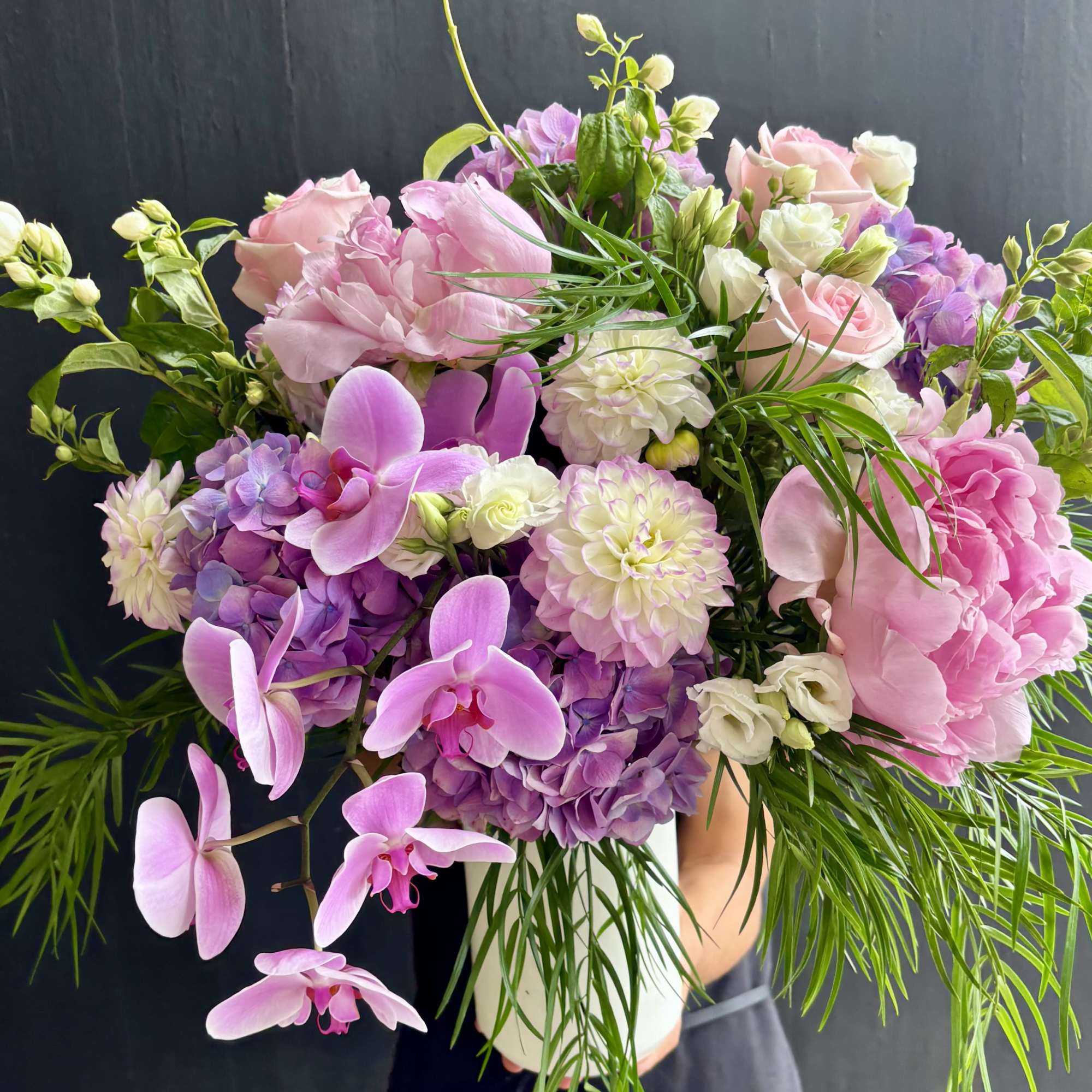 A bouquet of silky white roses, vibrant dahlias, peonies, and hydrangeas. 

Our