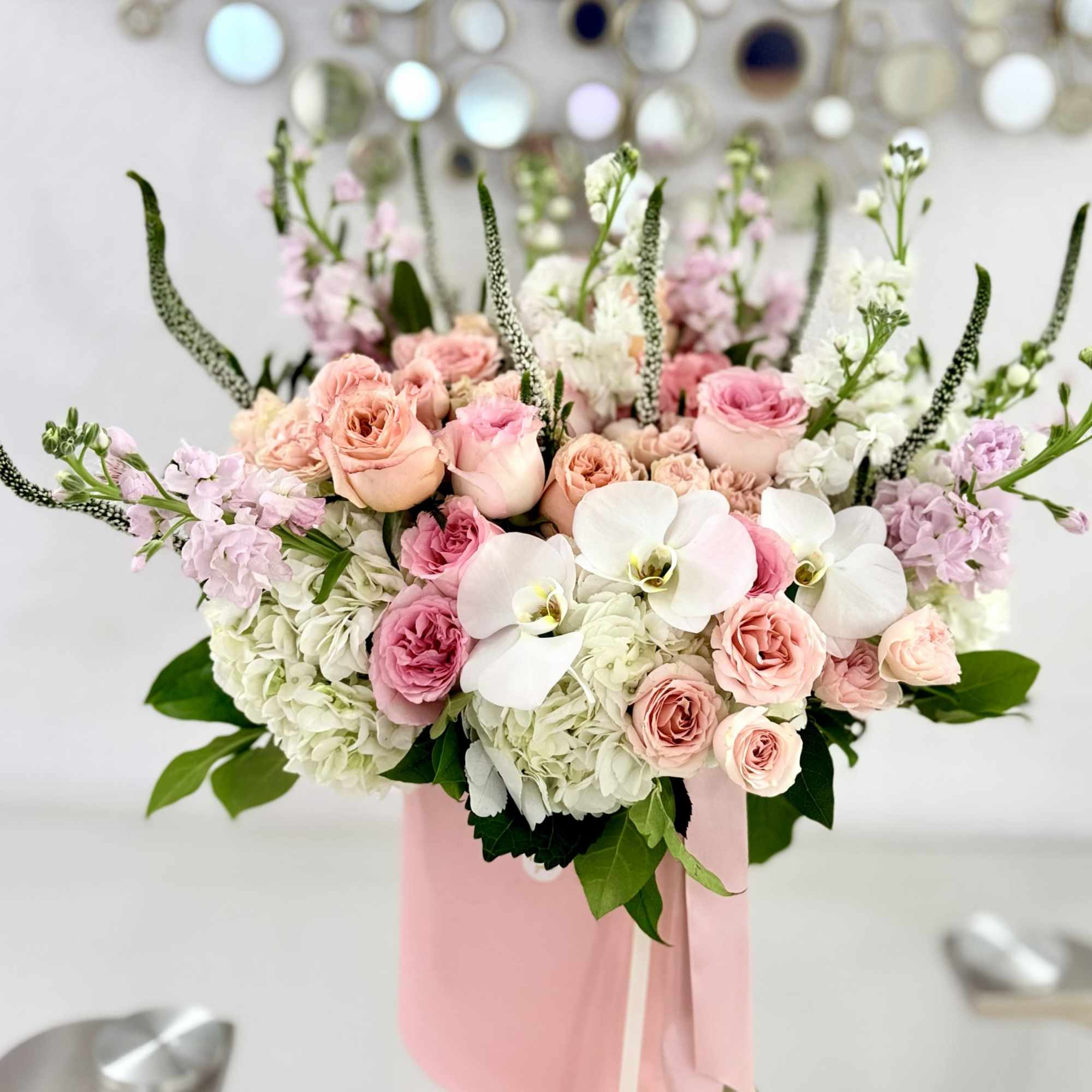 Soft blush and pink roses layered with creamy white hydrangeas and white