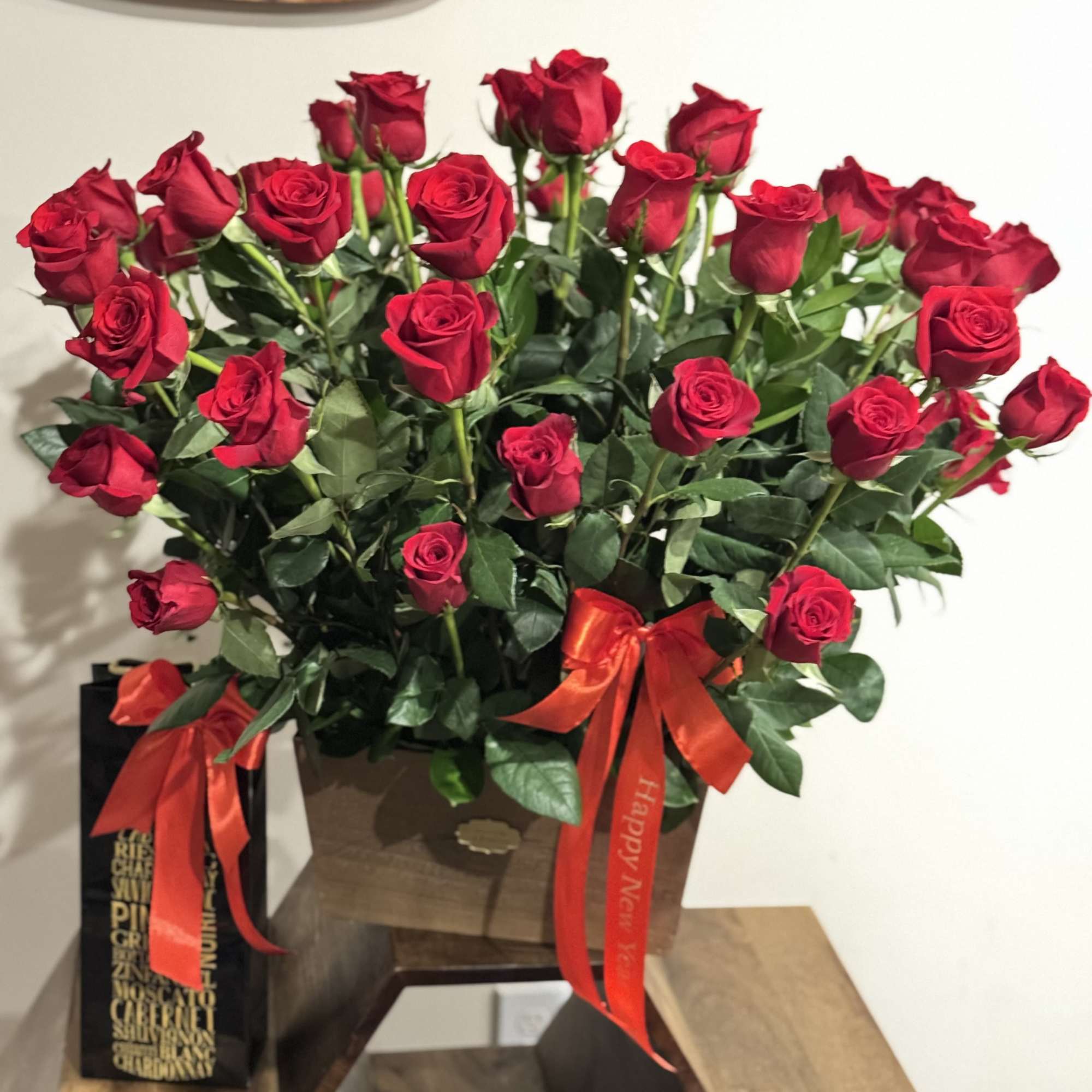 Bouquet of red roses in a brown box with red ribbons