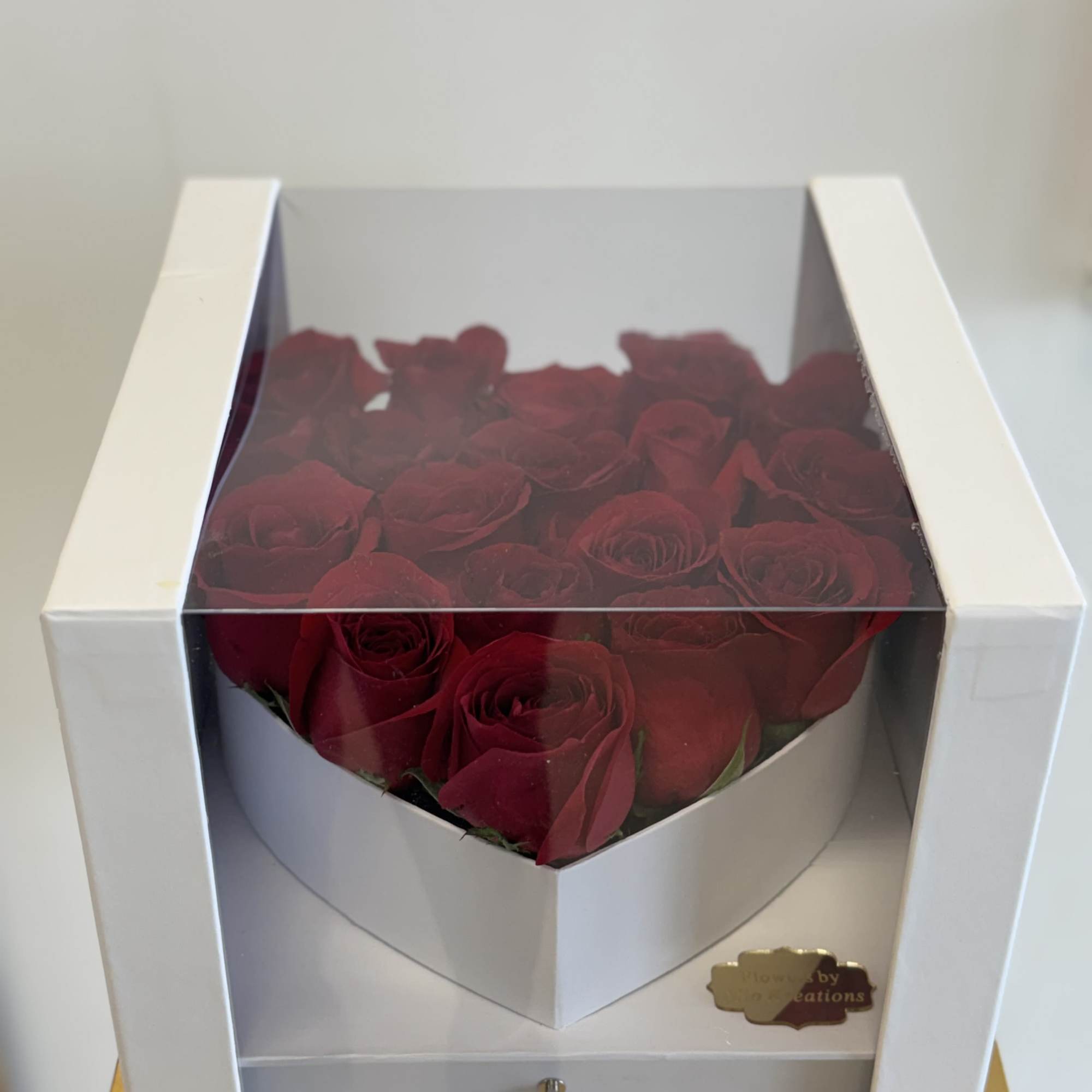 Boxed arrangement of red roses in a white gift box