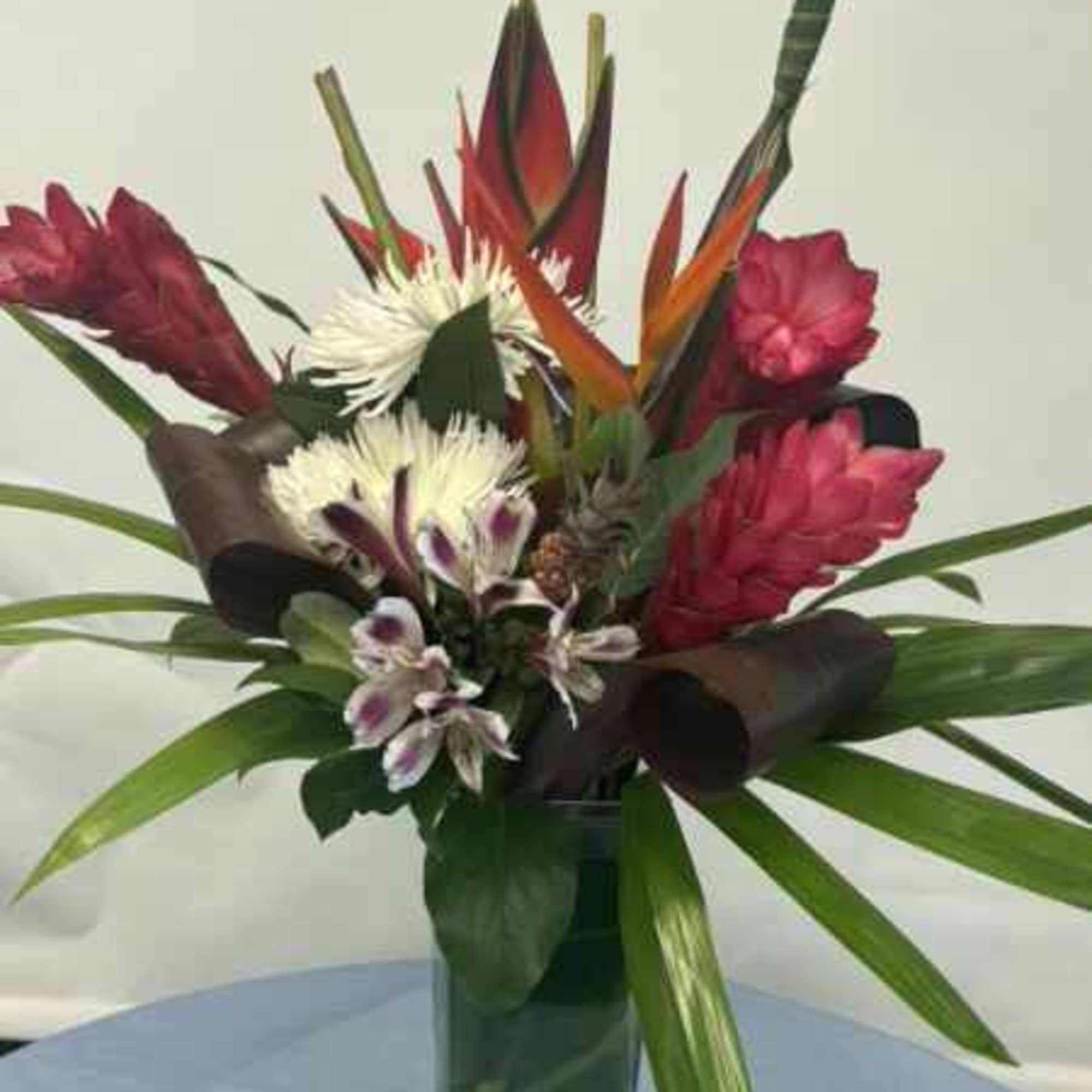 Bold, vertical tropical flair makes this flower arrangement a show-stopping choice for