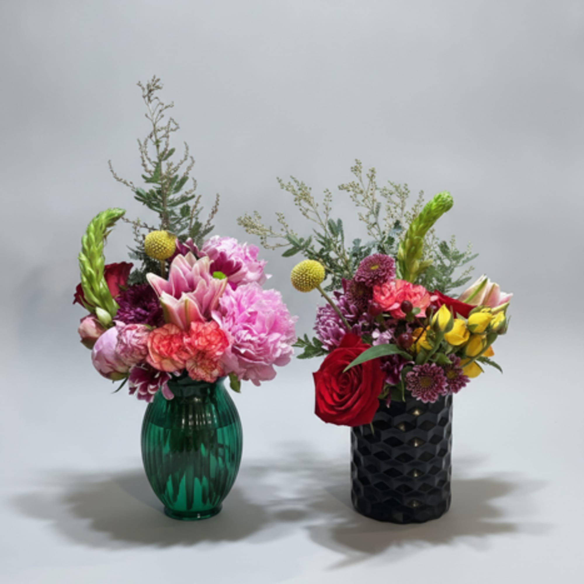 A lively cluster of mixed roses, lilies, carnations, and chrysanthemums in a