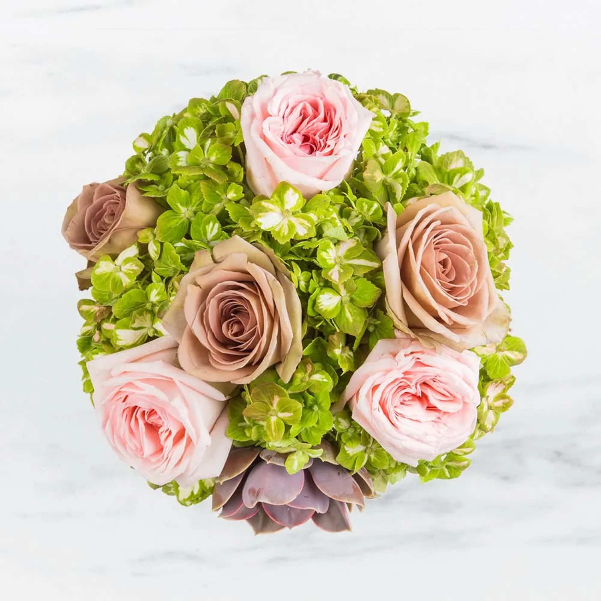 Round bouquet of pink and taupe roses with bright green hydrangea-like blooms