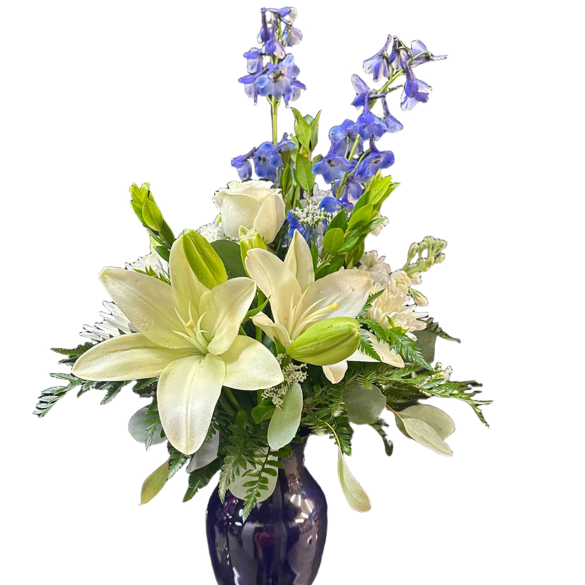 White lilies, blue delphinium, and chrysanthemums in a blue vase