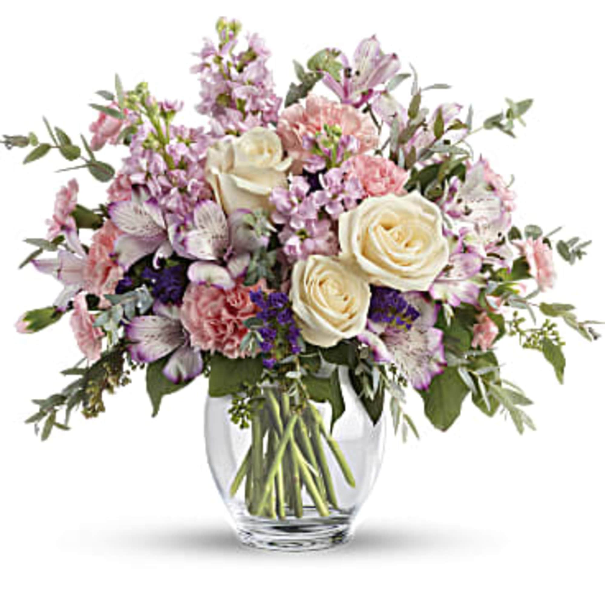Mixed pink and white flowers in a clear glass vase