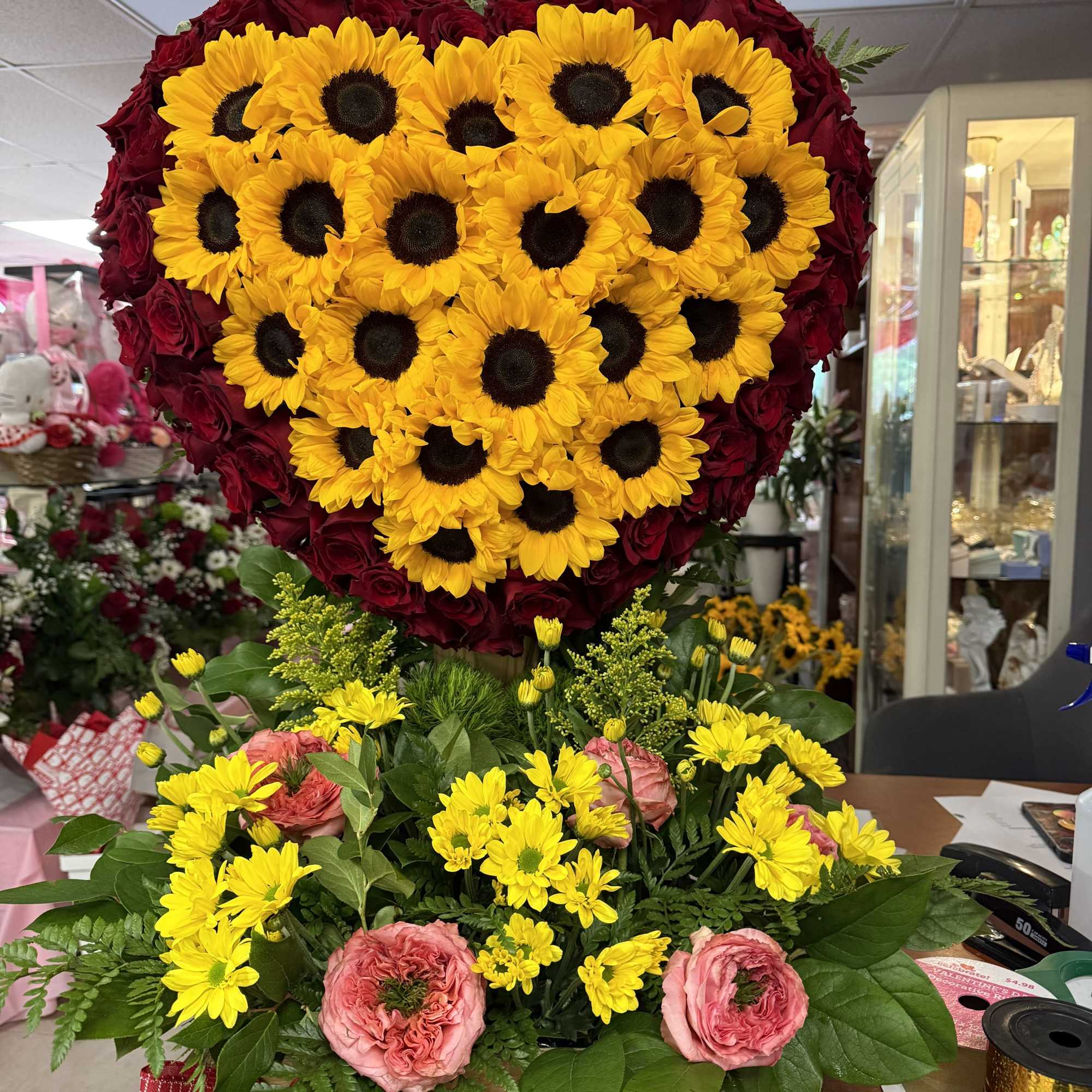 A bold heart-shaped flower arrangement that reads as a love-themed, celebratory gift-perfect